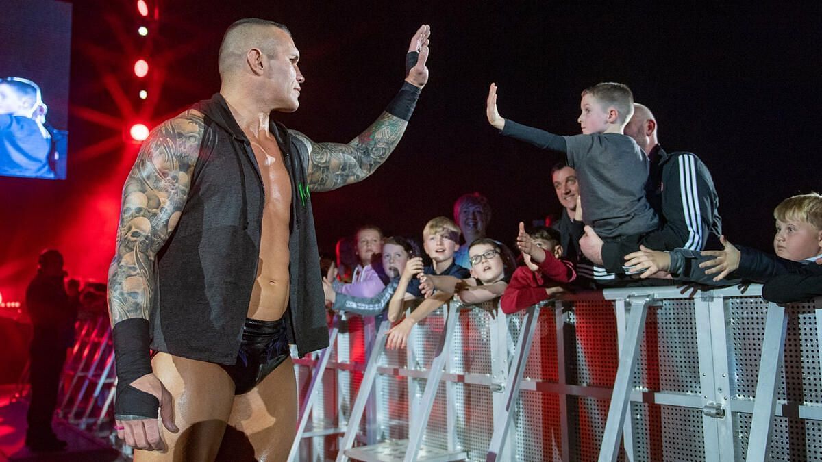 Orton interacting with a young fan at an event