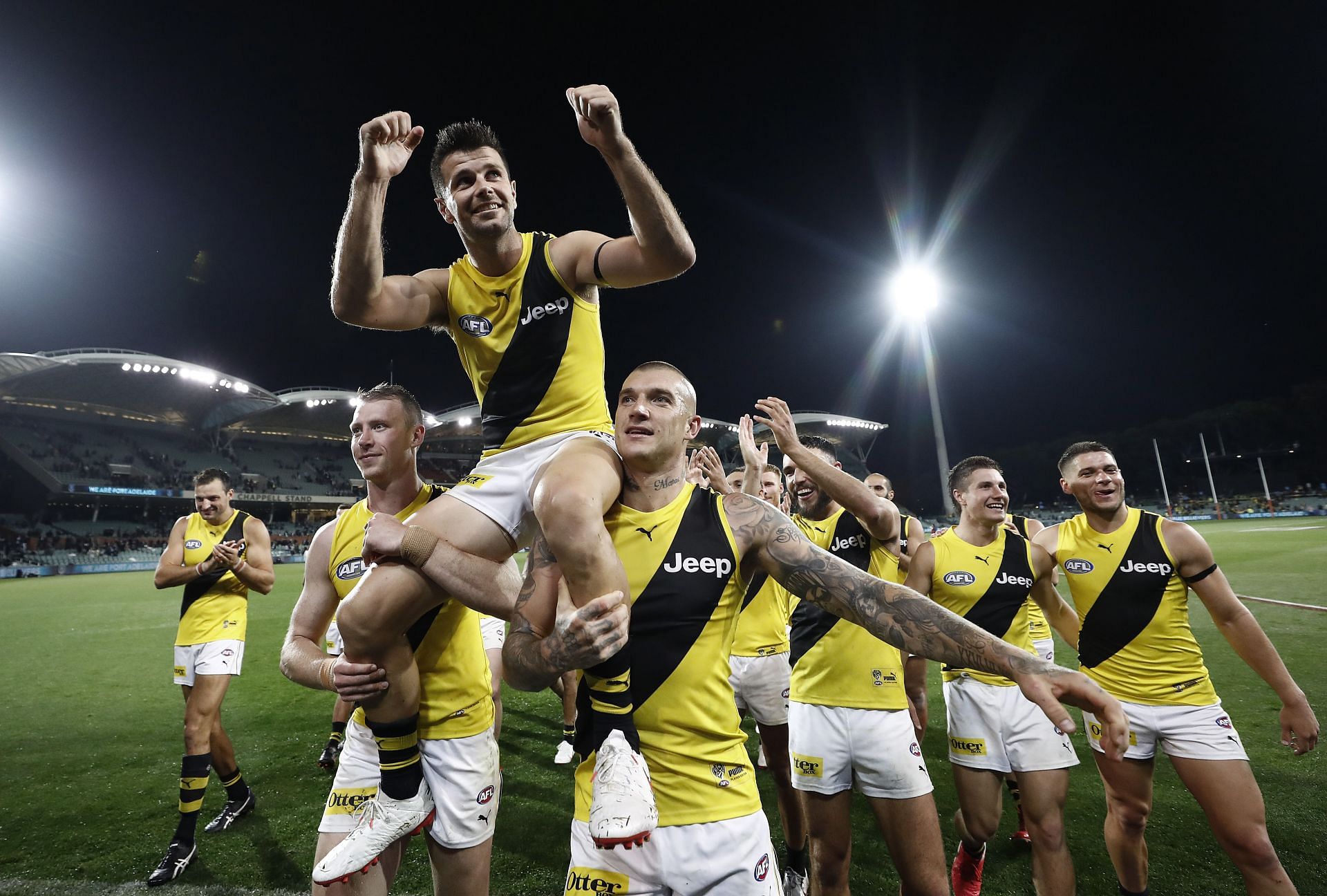 Trent Cotchin of the Tigers is chaired off by Dustin Martin of the Tigers after the Tigers defeated the Power