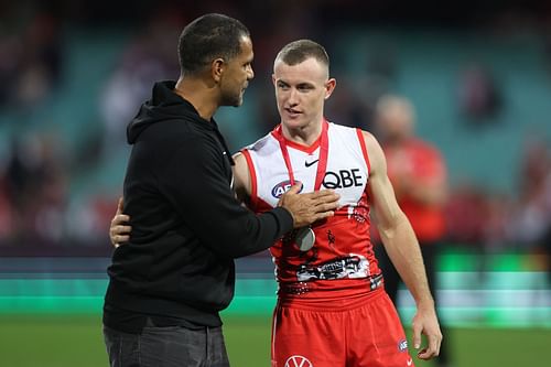 Chad Warner of the Swans receives the player of the match award from Michael O'Loughlin