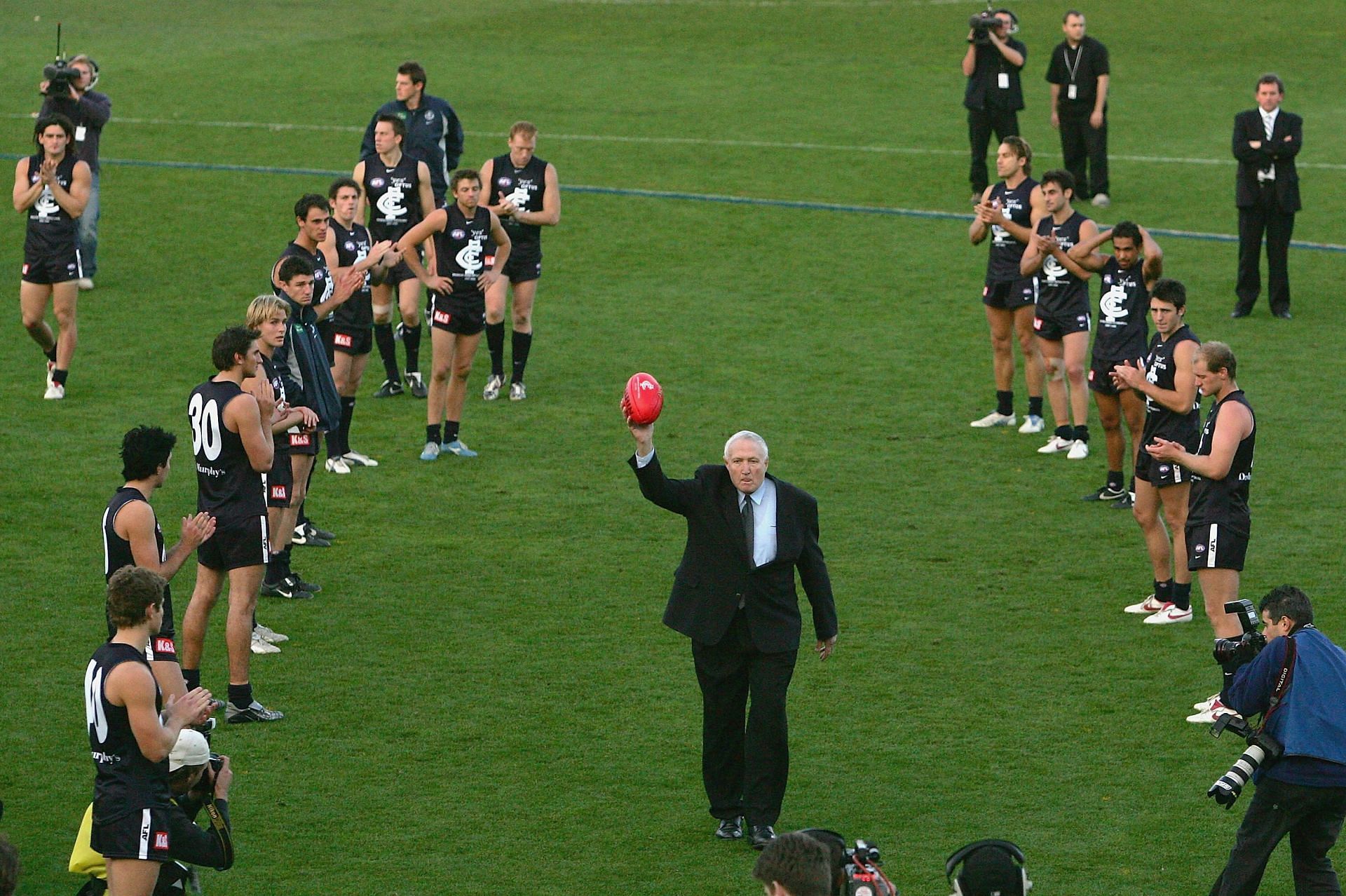 John Nicholls Carlton legend carries the match ball from the field