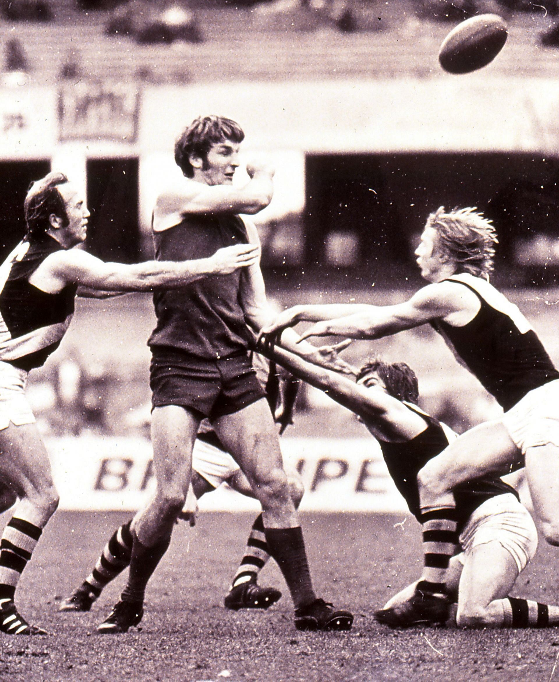 A Melbourne player handballs during a match