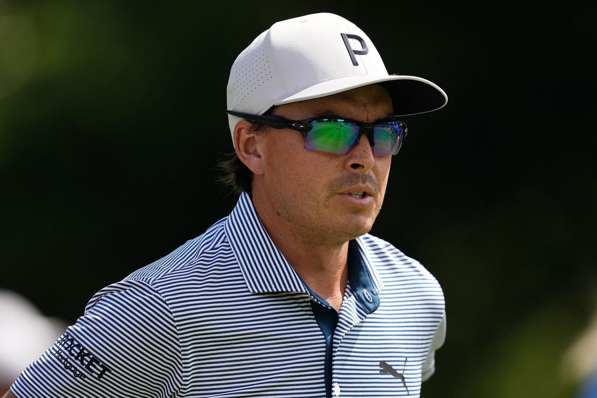 Why does Rickie Fowler wear sunglasses while playing?