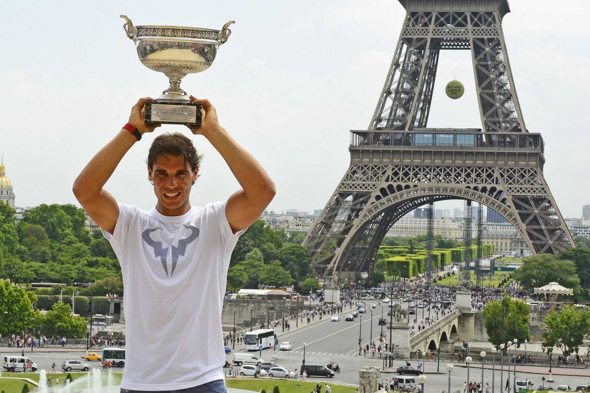 Rafael Nadal lifts the trophy above his head during his French Open 2014 photoshoot