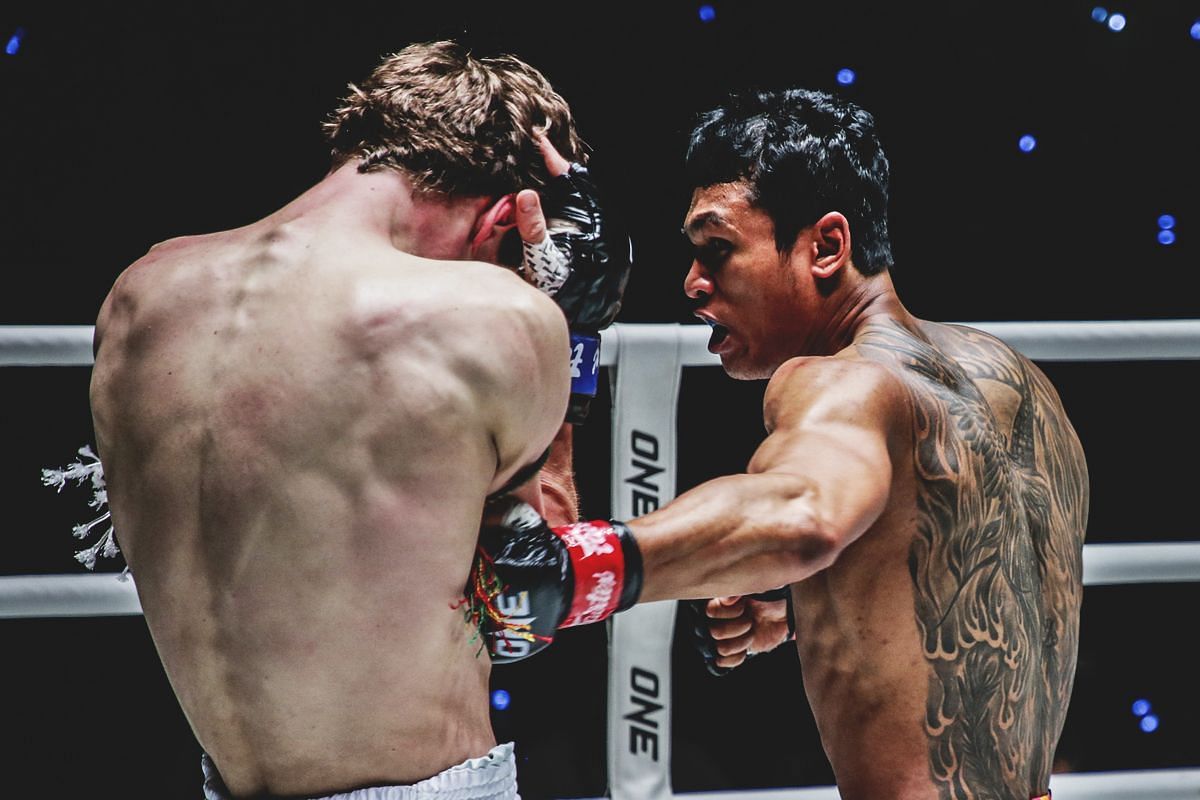 Jo Nattawut lands a punch against Luke Lessei.