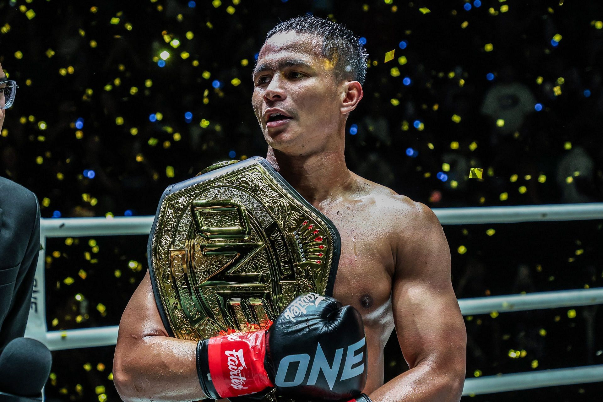 Superbon celebrates after defeating Marat Grigorian to win the ONE featherweight kickboxing title.