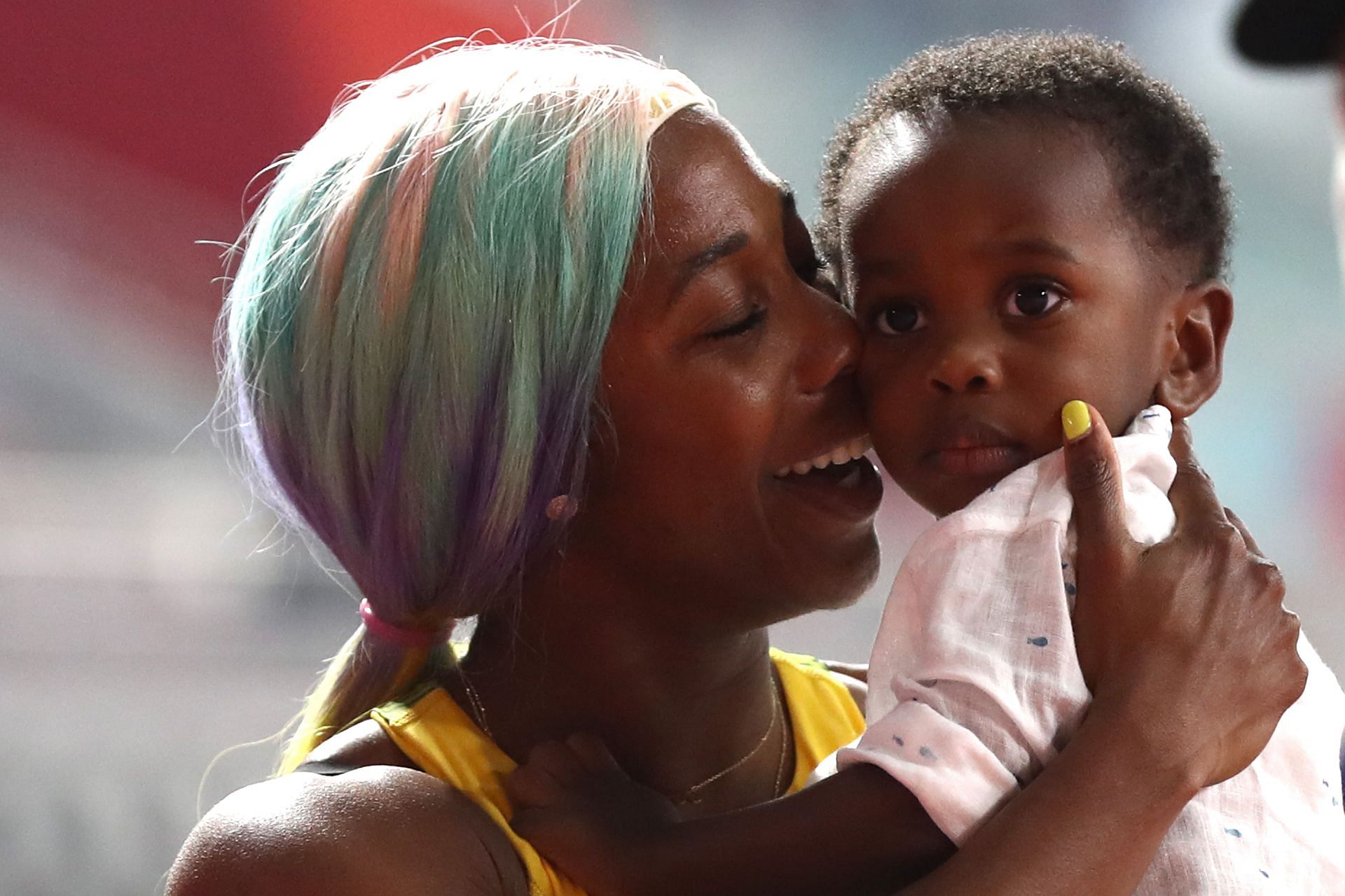 Shelly-Ann Fraser-Pryce of Jamaica celebrates with her son Zyon after winning the Women&#039;s 100 Metres final during the 17th IAAF World Athletics Championships 2019 at Khalifa International Stadium in Doha, Qatar
