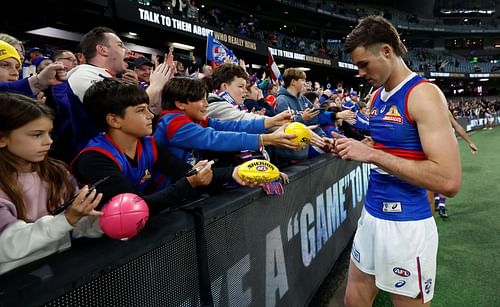 Sam Darcy of the Bulldogs signs autographs for fans