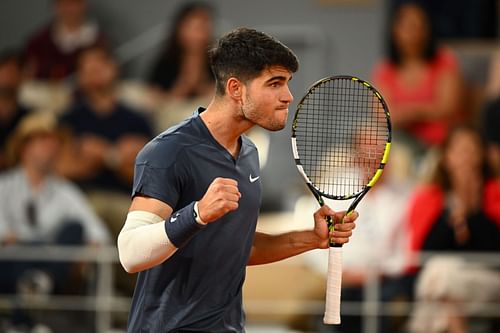 Carlos Alcaraz celebrates after winning his first-round match at the 2024 French Open against J.J. Wolf