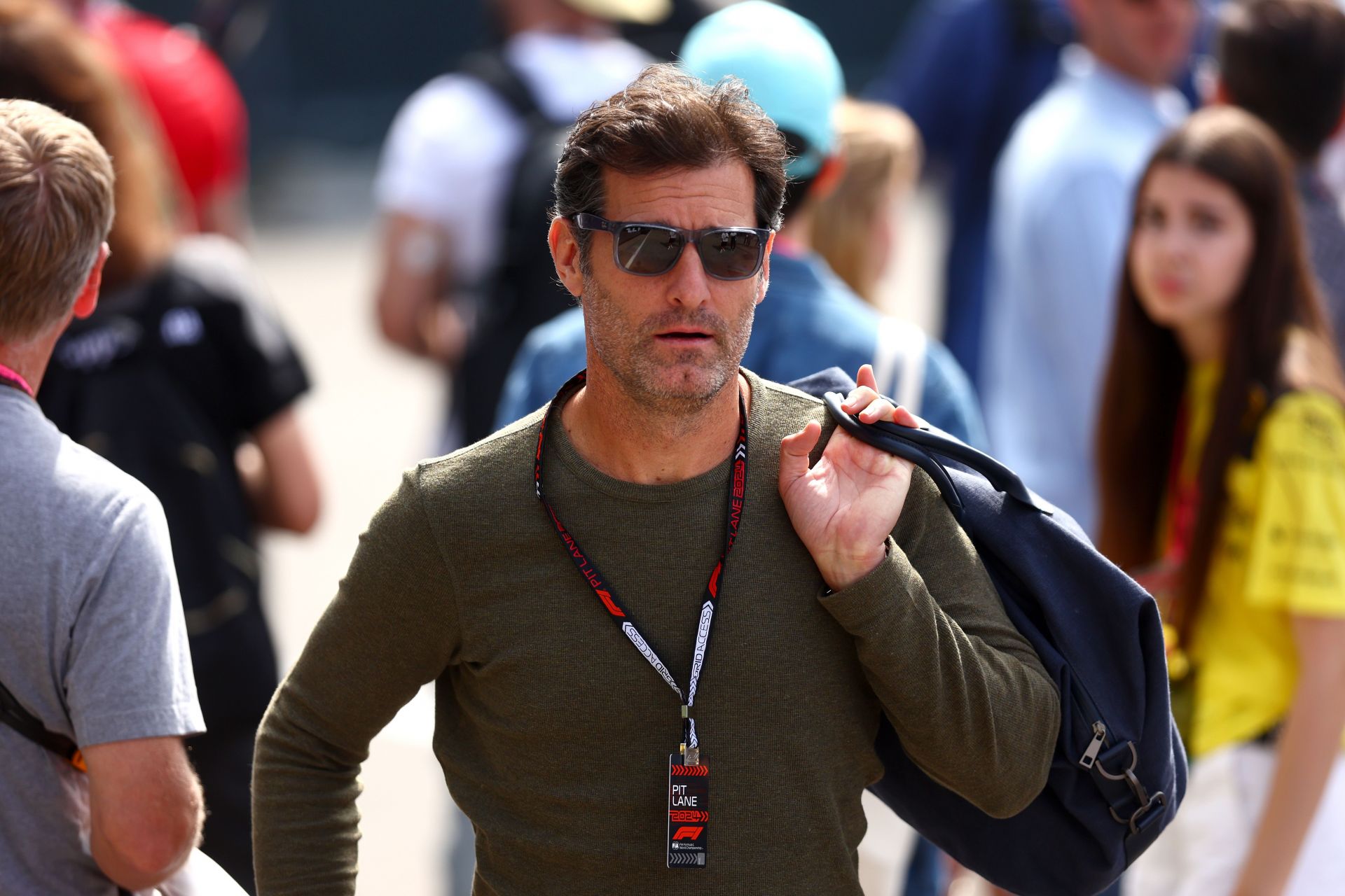 Mark Webber walks in the Paddock