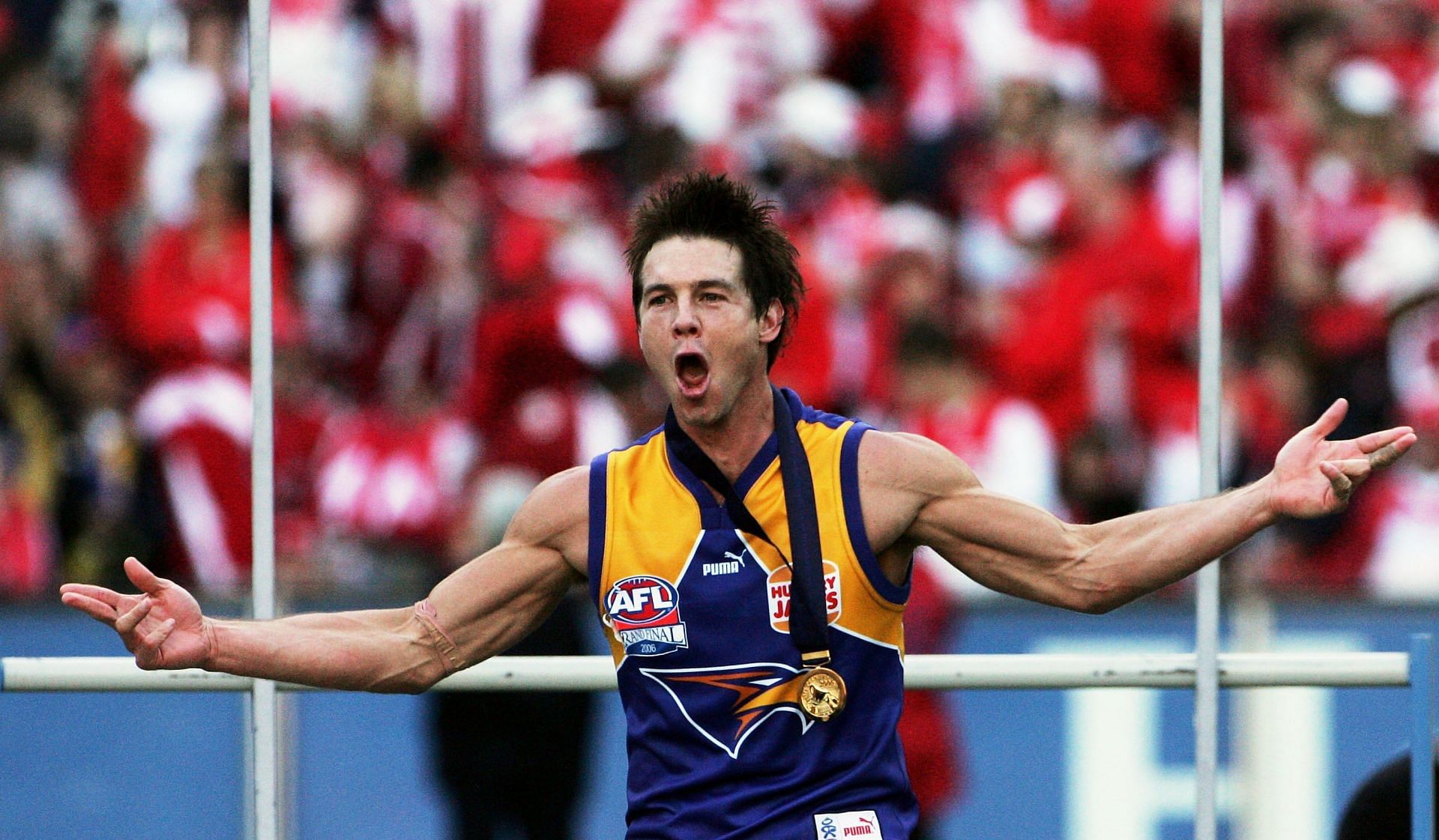 Ben Cousins of the Eagles celebrates after receiving his medal after the AFL Grand Final match in 2006