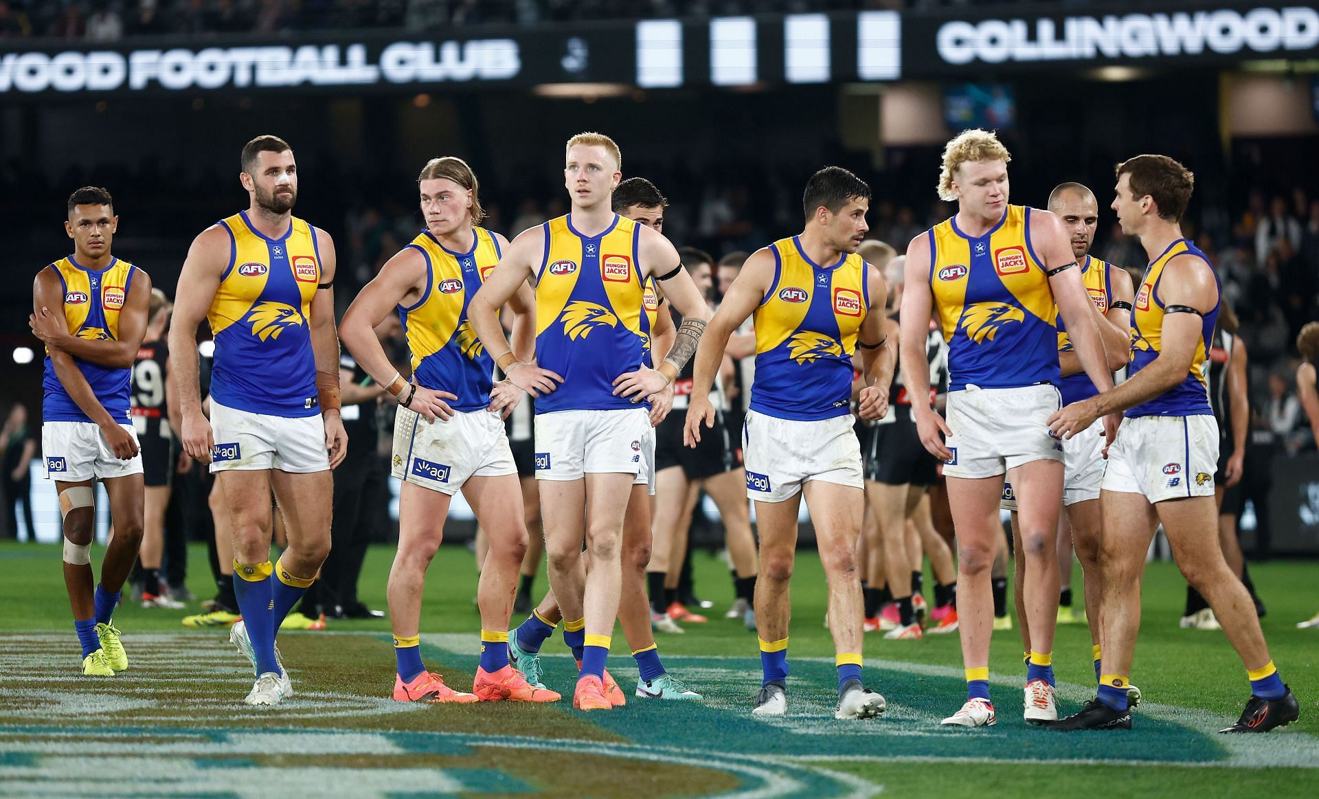 Eagles players look dejected after a loss during the 2024 AFL round nine match between the Collingwood Magpies and the West Coast Eagles