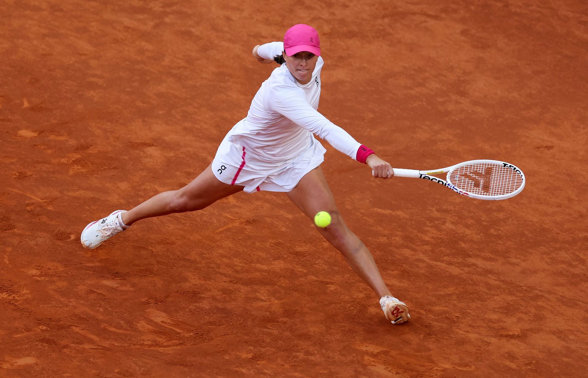 Iga Swiatek retrieves a ball during the Madrid Open final.