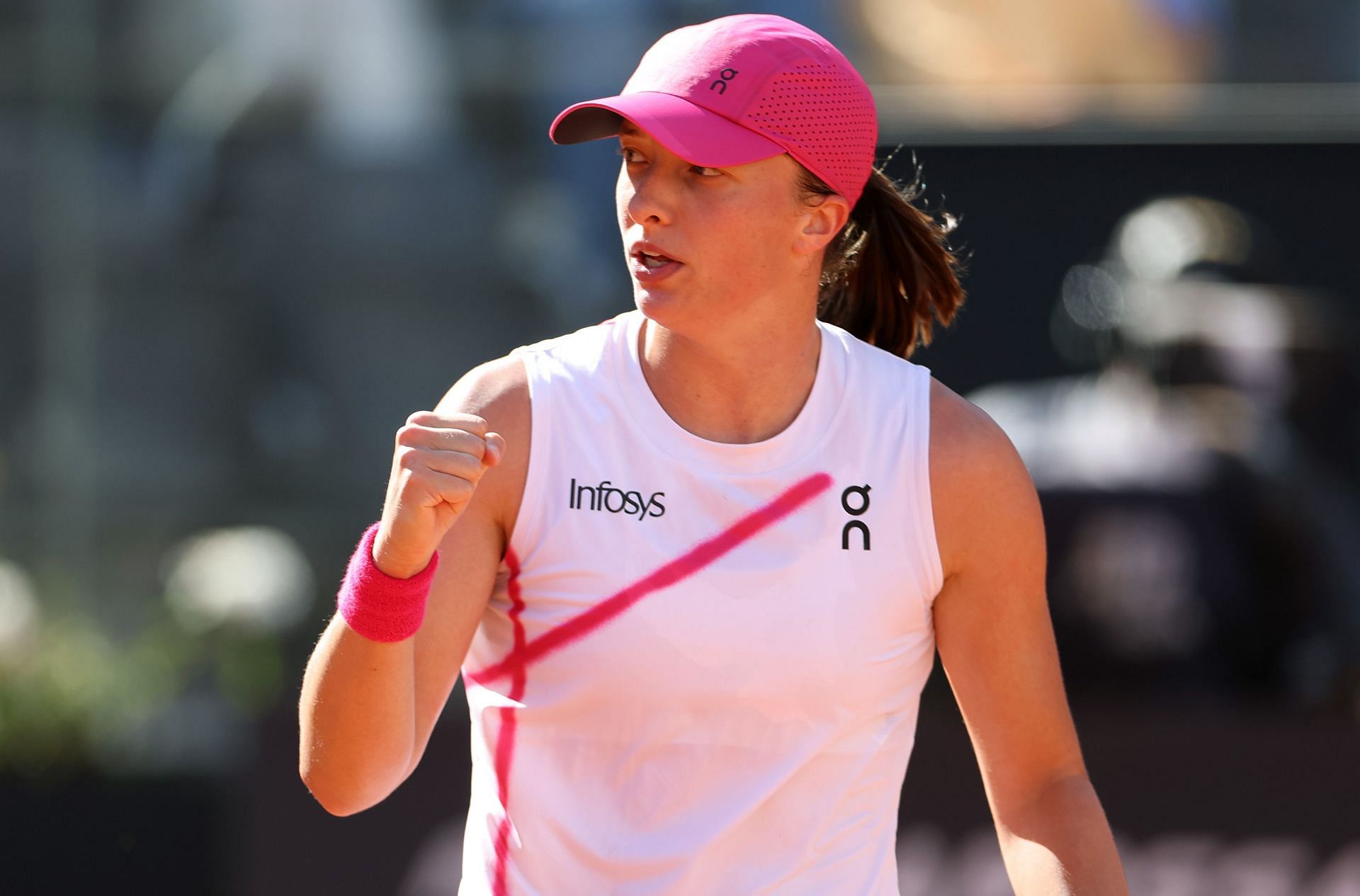 Iga Swiatek pumps her fist during her Italian Open SF against Coco Gauff