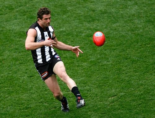 Shane O'Bree of the Magpies kicks the ball