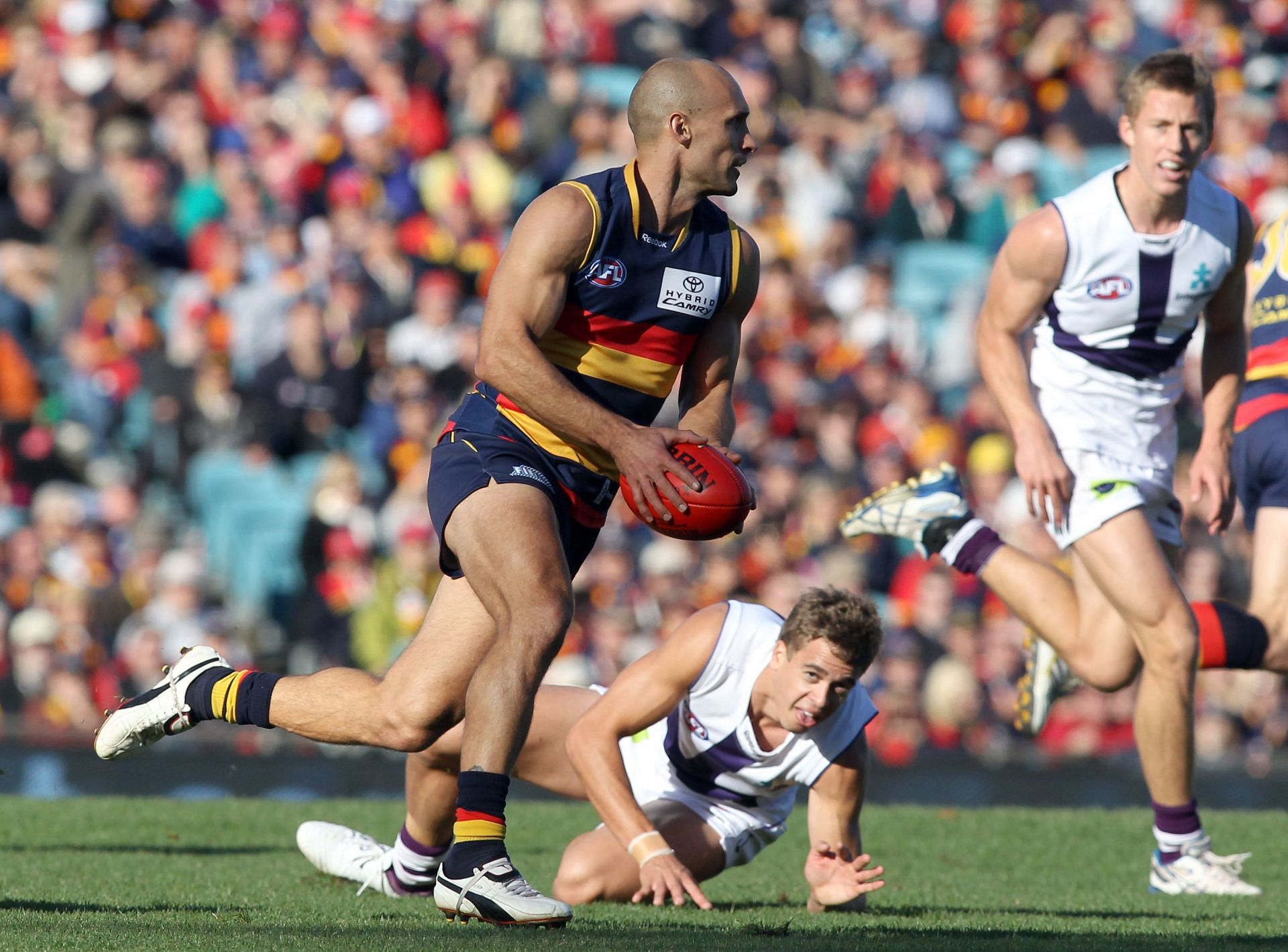 Tyson Edwards of the Crows runs with the ball