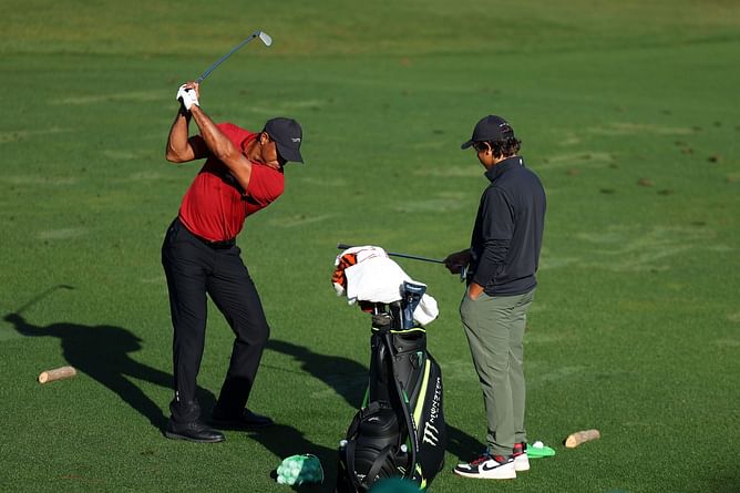 "He puts the club there to help me to turn" - Tiger Woods explains Charlie's training help at the Masters practice range