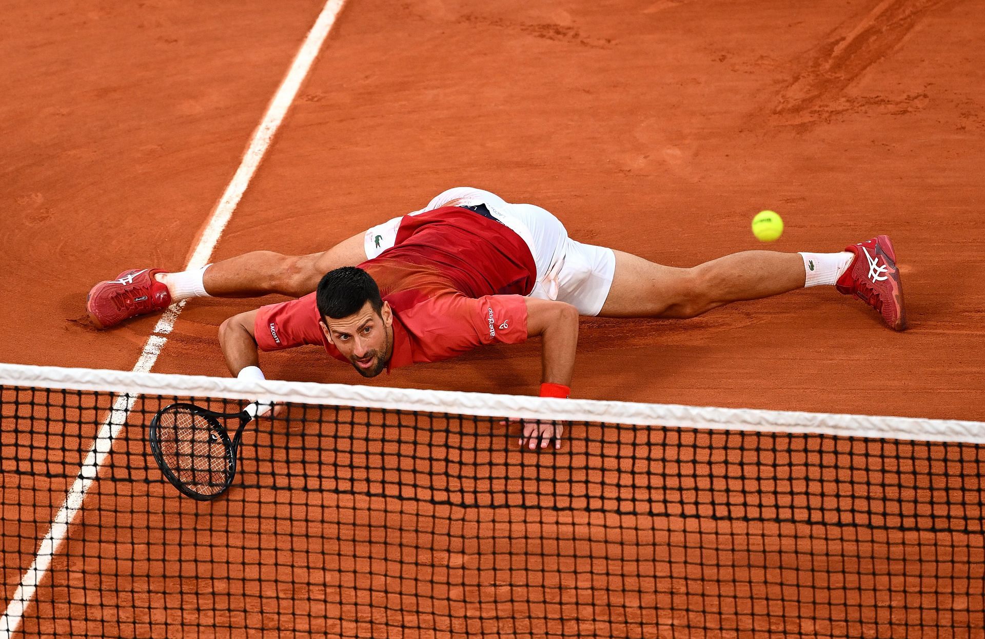 Novak Djokovic stretches to return a ball at the 2024 French Open. Photo: Getty