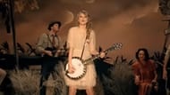 Taylor plays the banjo (photo via YouTube/ Taylor Swift/ Mean)