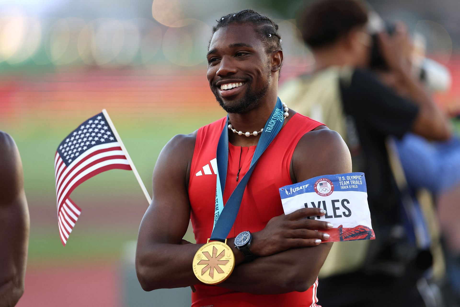 Noah Lyles poses with the flag and the gold medal after winning the men&#039;s 100M final at the 2024 U.S. Olympic Team Trials Track &amp; Field at Hayward Field on June 23, 2024, in Eugene, Oregon. (Getty Images)