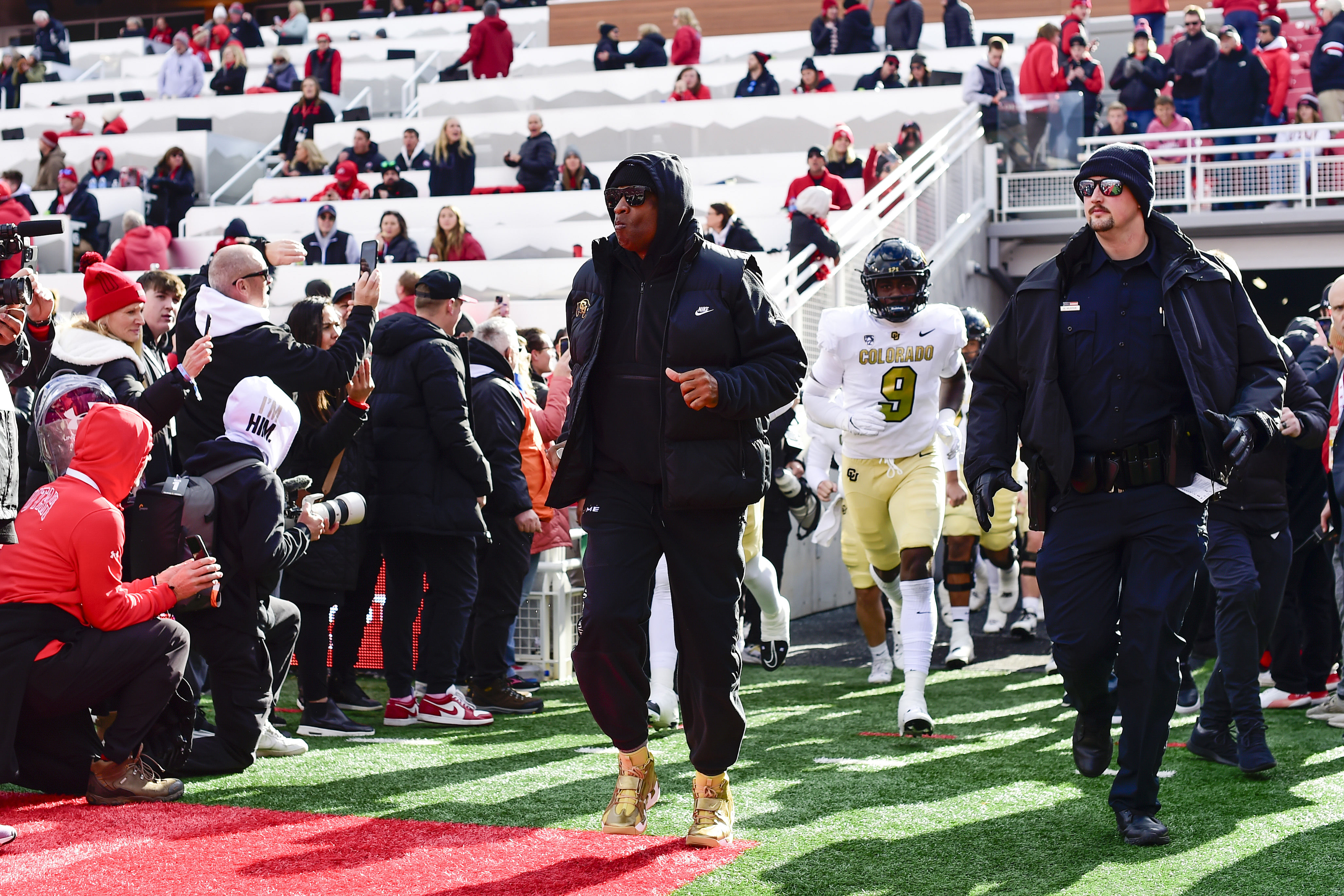 Colorado Buffaloes head coach Deion &#039;Coach Prime&#039; Sanders runs out on the field.