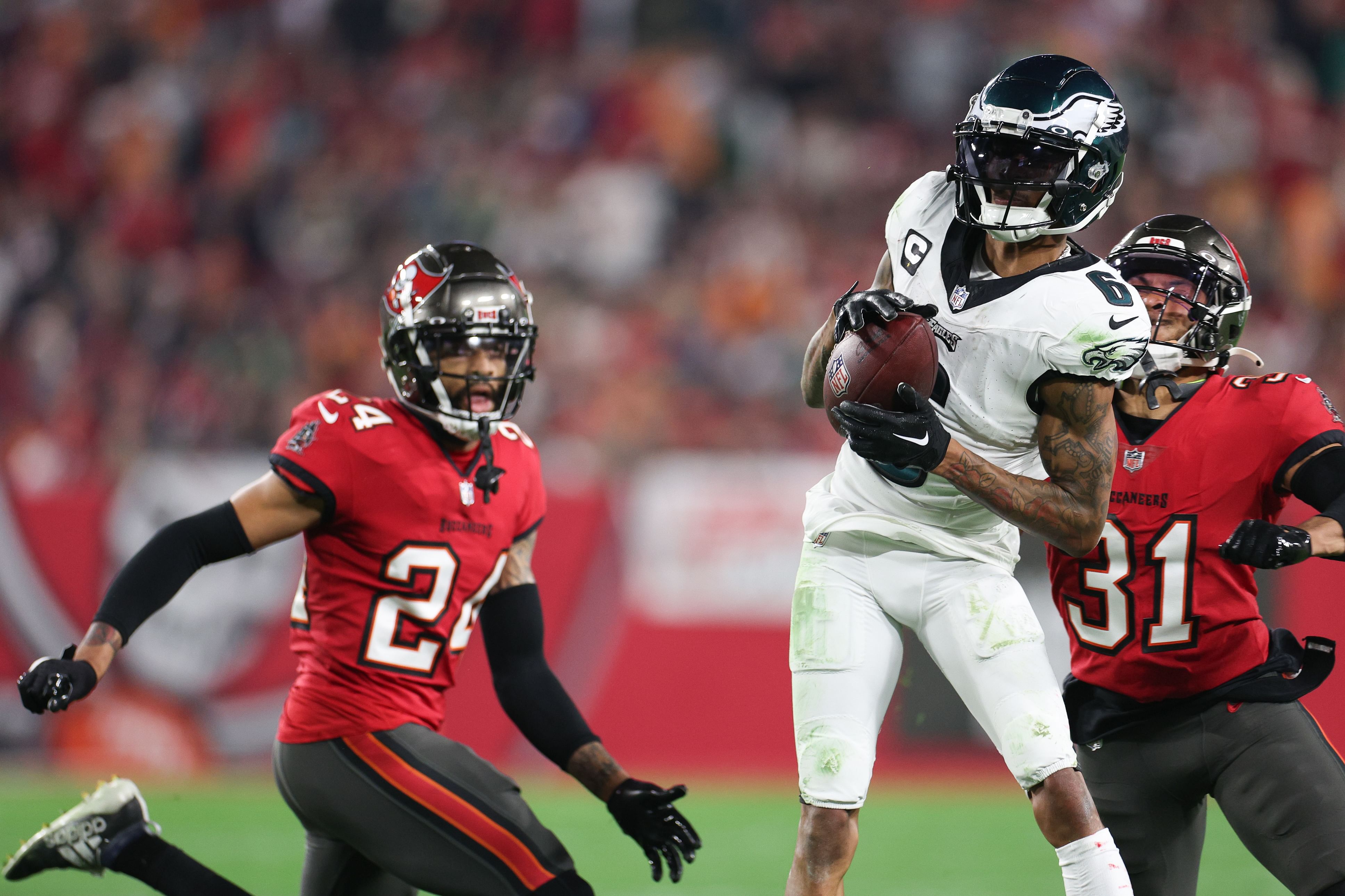 NFL: NFC Wild Card Round: Jan 15, 2024; Tampa, Florida, USA; Philadelphia Eagles wide receiver DeVonta Smith (6) makes a catch as Tampa Bay Buccaneers safety Antoine Winfield Jr. (31) and cornerback Carlton Davis III (24) defend during the second half of a 2024 NFC wild card game at Raymond James Stadium. Mandatory Credit: Nathan Ray Seebeck-USA TODAY Sports