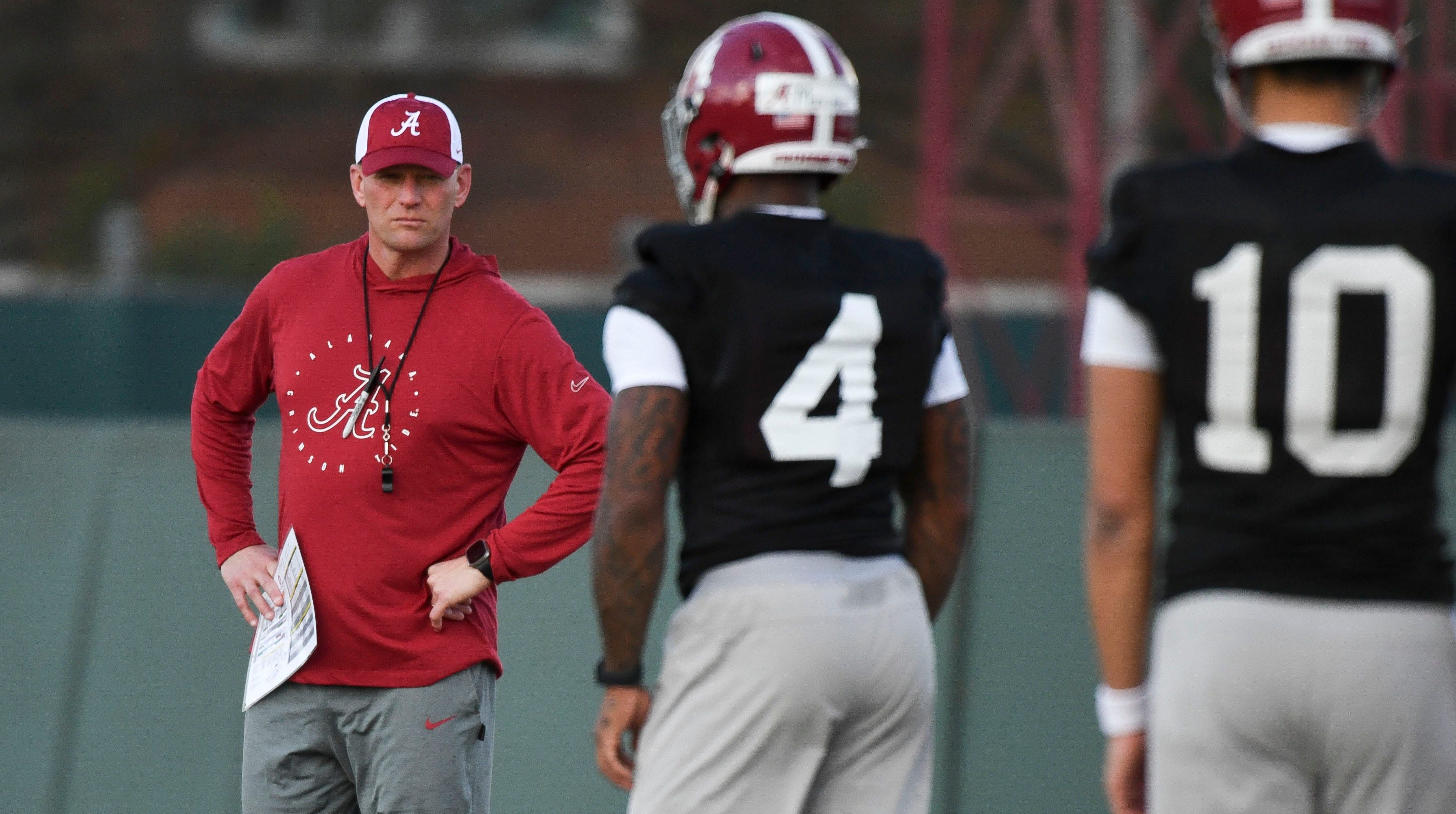 Alabama coach Kalen DeBoer watches his quarterbacks go through drills during practice.