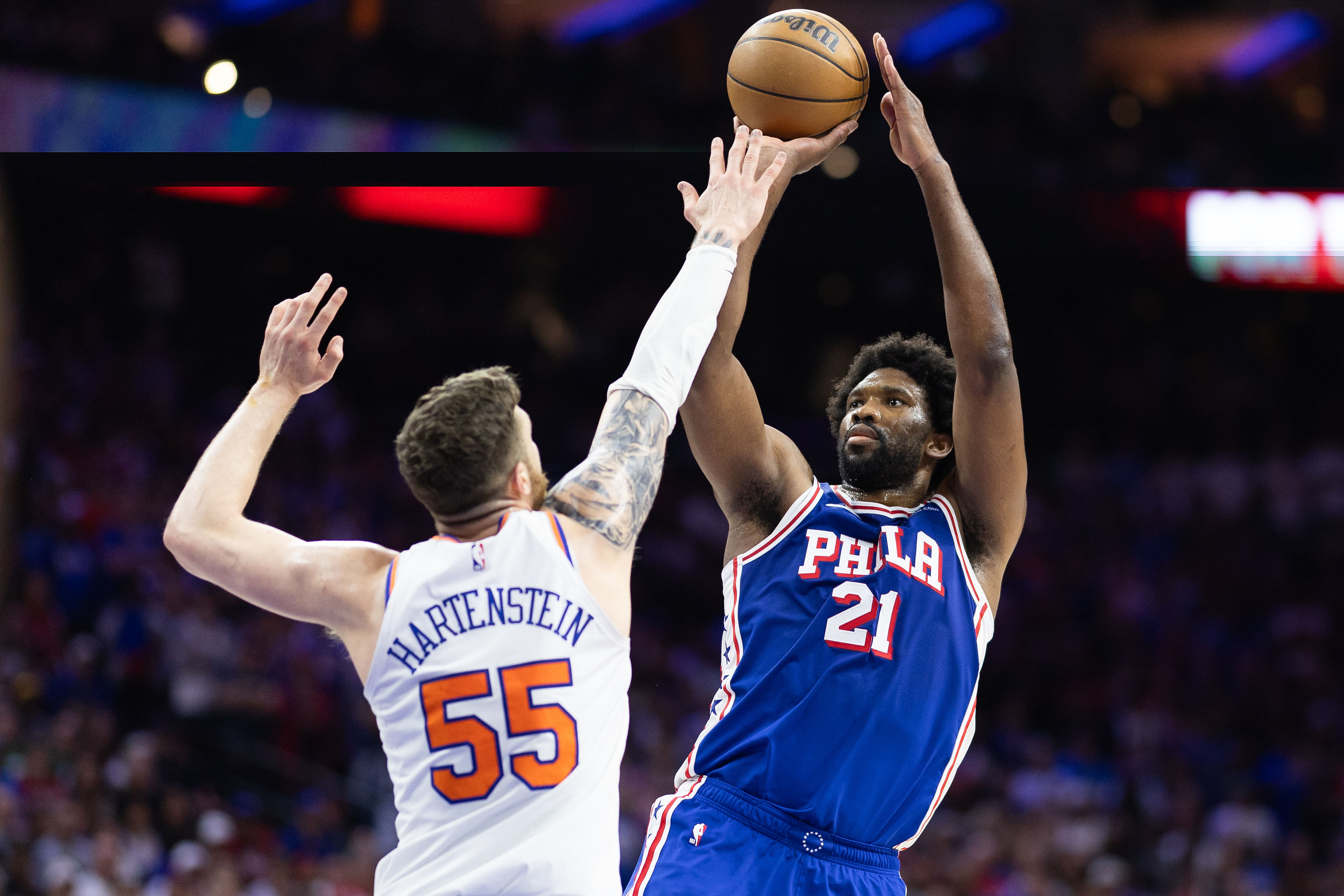 Philadelphia 76ers center Joel Embiid shooting over New York Knicks center Isaiah Hartenstein