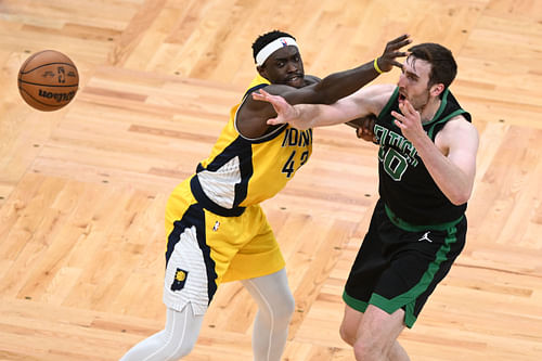 NBA Draft prospect and UConn center Donovan Clingan is being compared to Boston Celtics backup center Luke Kornet (right).