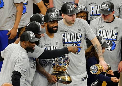 Kyrie Irving celebrates Western Conference finals trophy with Dallas Mavericks teammates