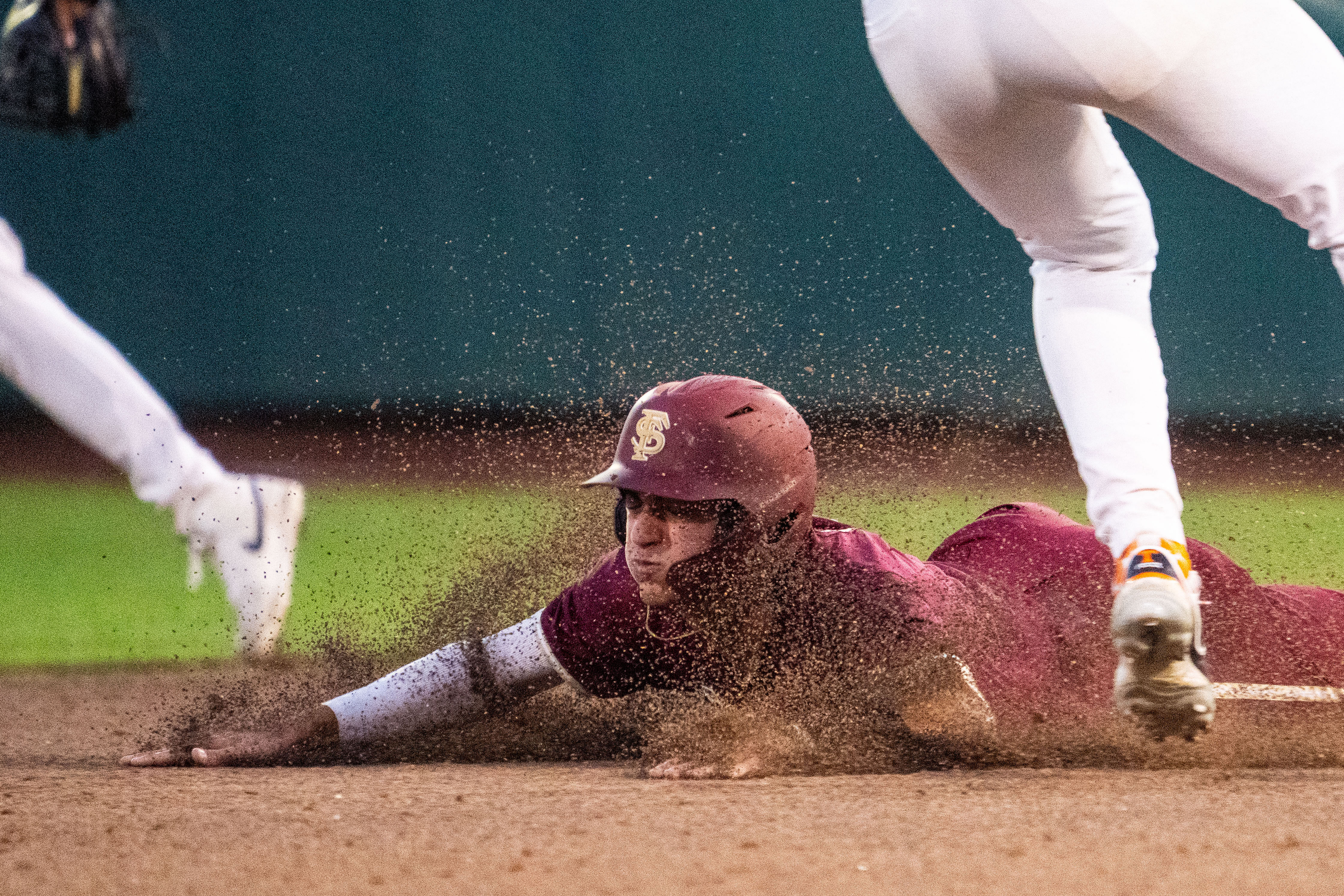 Florida State shortstop Alex Lodise slid safely to second base.