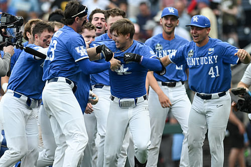 Mitchell Daly celebrates with teammates following Kentucky's 10th-inning walk-off win over NC State.