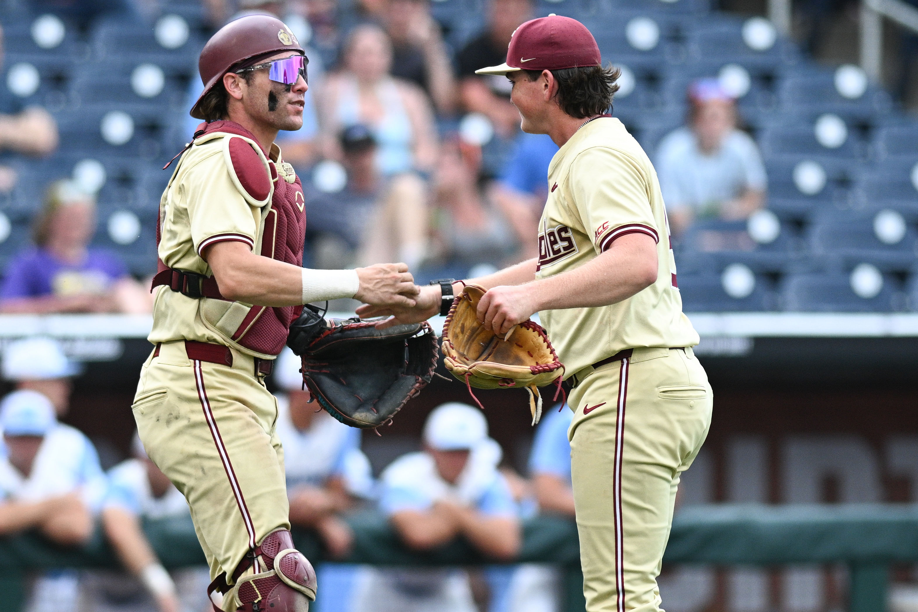 Florida State Seminoles pitcher Connor Hults (15) and catcher Jaxson West (20) celebrate after defeating the North Carolina Tar Heels at Charles Schwab Field Omaha.