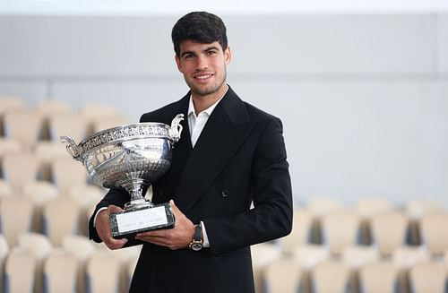 Carlos Alcaraz with the 2024 French Open trophy.