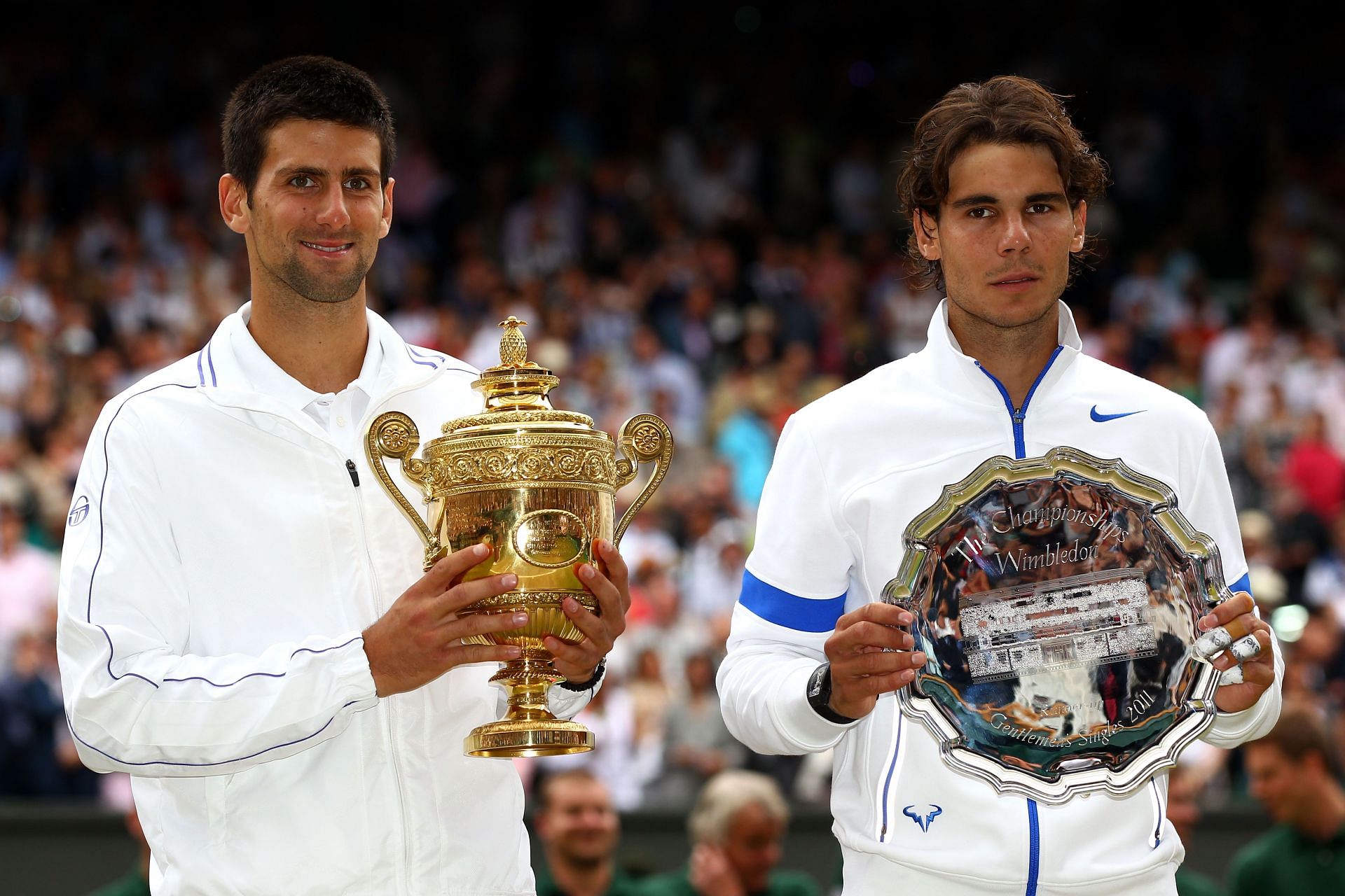 Novak Djokovic with the winner and Rafael Nadal with the runner-up trophy at the 2011 Wimbledon.