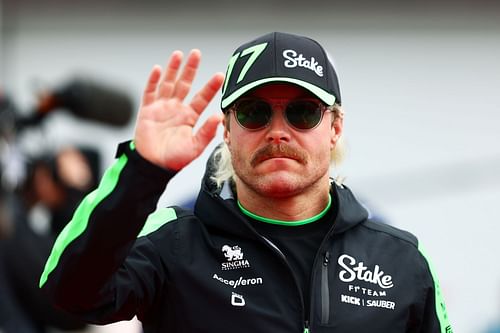 MONTREAL, QUEBEC - JUNE 09: Valtteri Bottas of Finland and Stake F1 Team Kick Sauber waves to the crowd on the drivers parade prior to the F1 Grand Prix of Canada