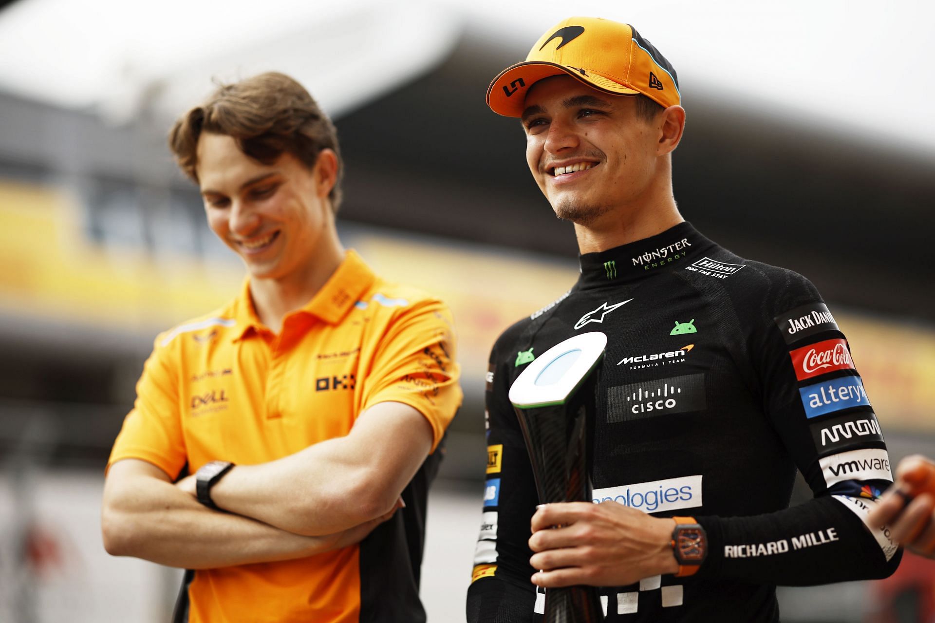 Second placed Lando Norris of Great Britain and McLaren smiles with his trophy and teammate Oscar Piastri of Australia and McLaren after the F1 Grand Prix of Spain at Circuit de Barcelona-Catalunya on June 23, 2024 in Barcelona, Spain. (Photo by Chris Graythen/Getty Images)