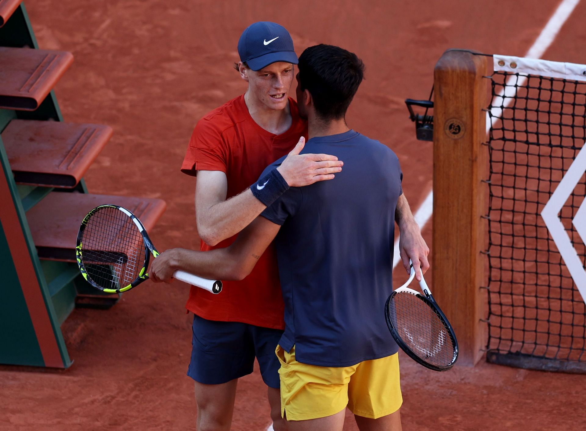 Jannik Sinner and Carlos Alcaraz embrace after 2024 French Open SF
