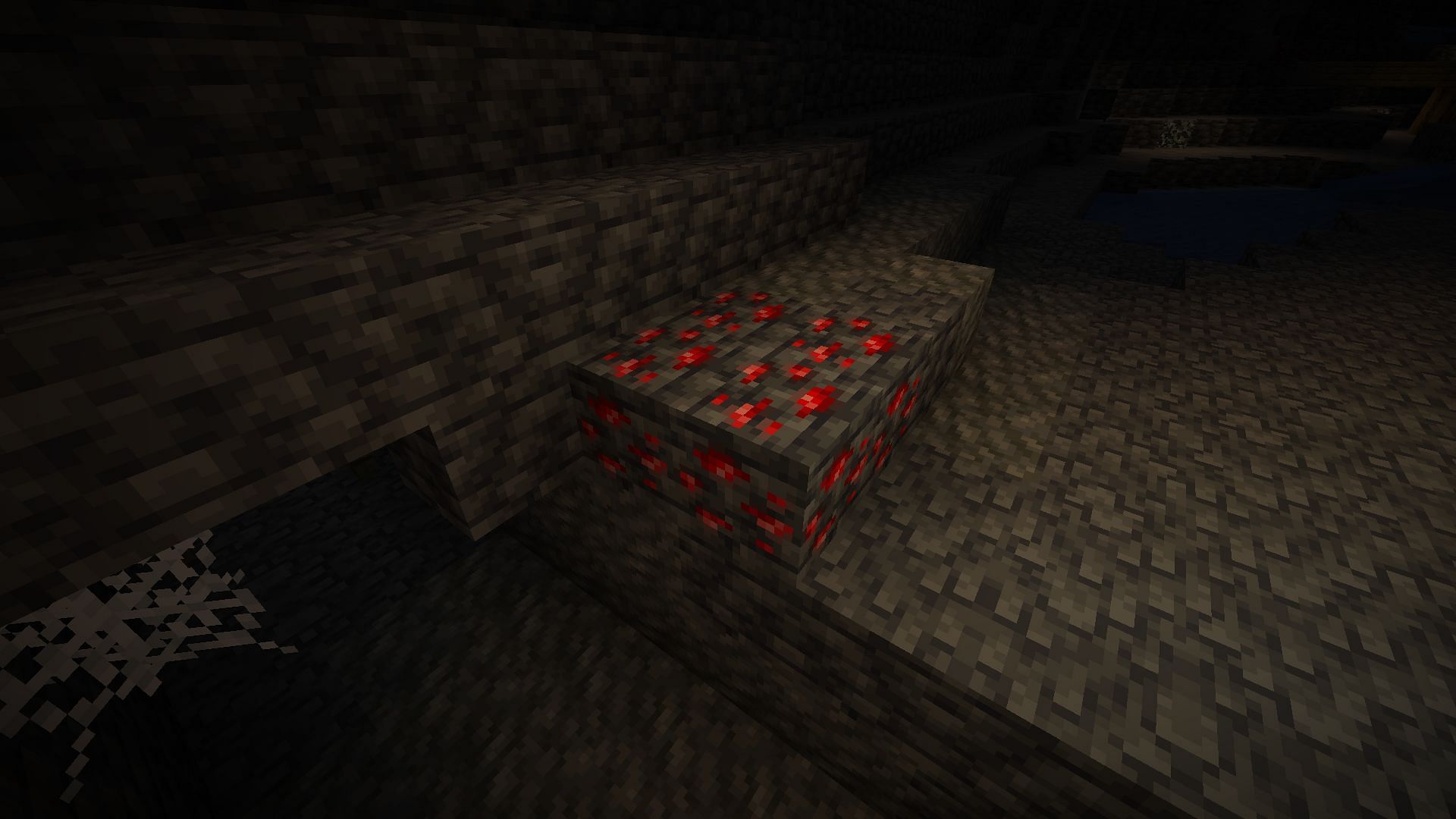 Redstone ore in a cave near a mineshaft (Image via Mojang)