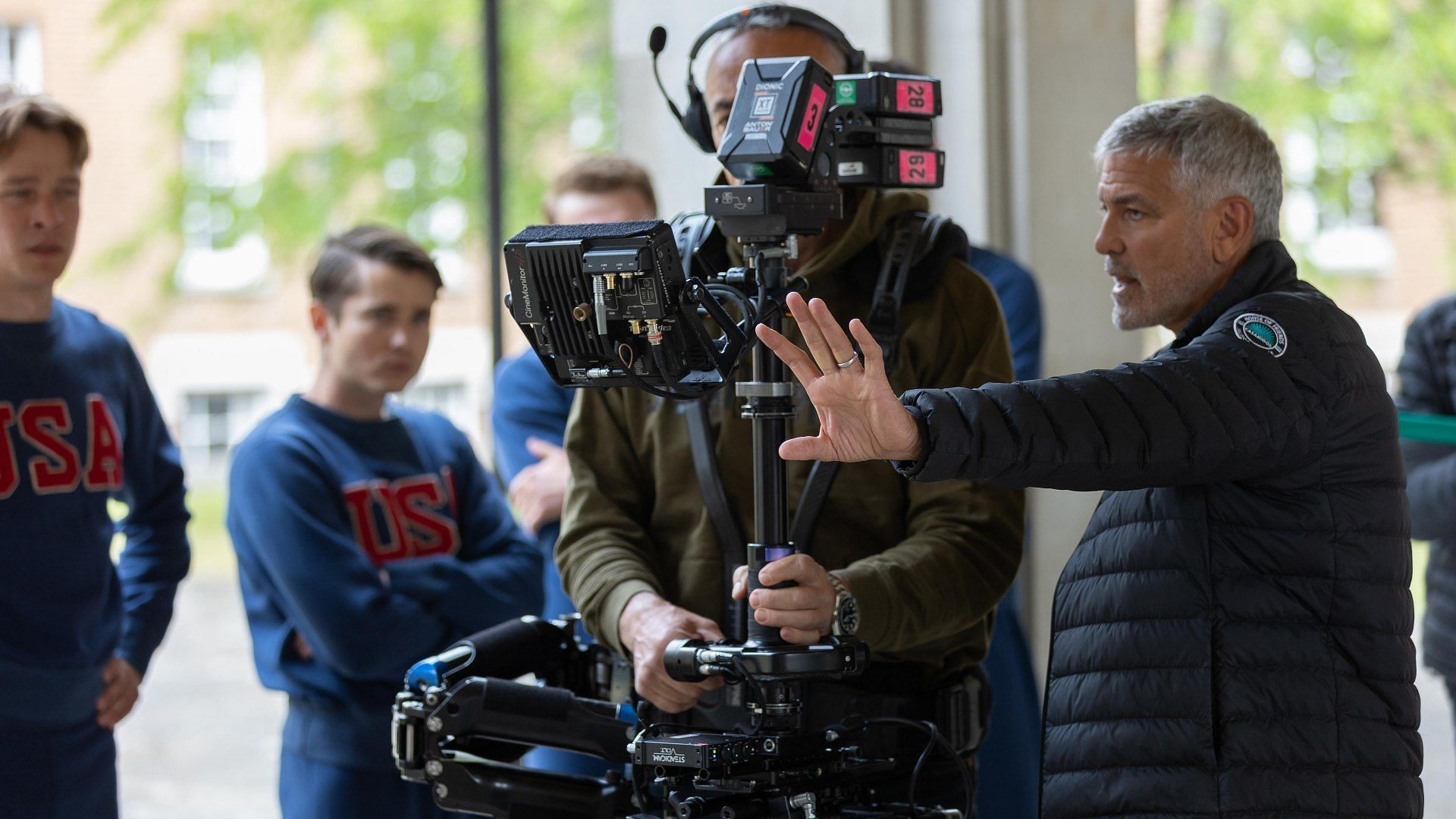 George Clooney directing a scene from The Boys in the Boat (Image via IMDb)