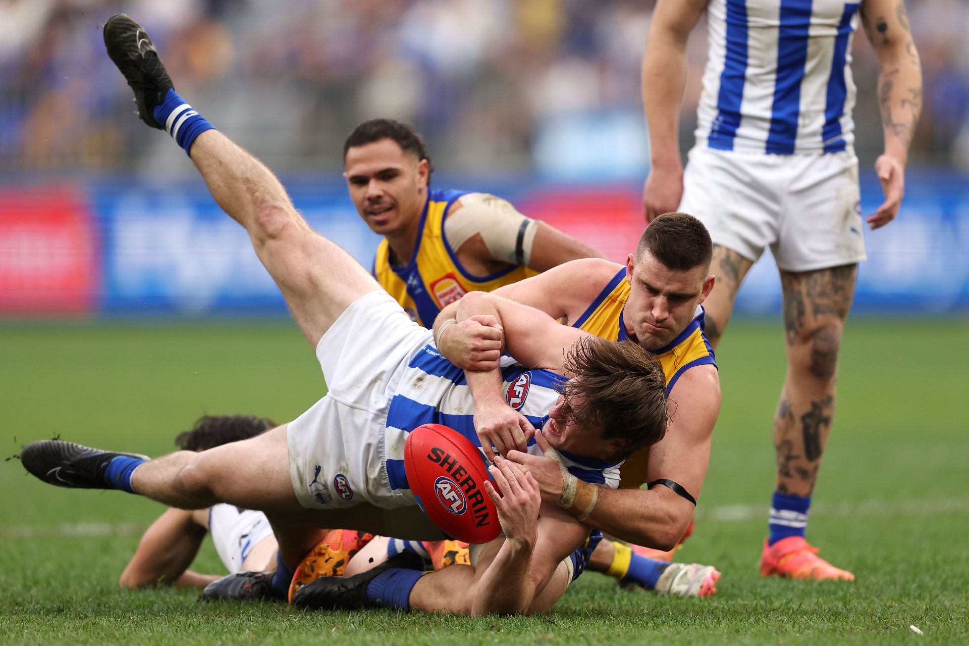 Elliot Yeo of the Eagles tackles George Wardlaw of the Kangaroos