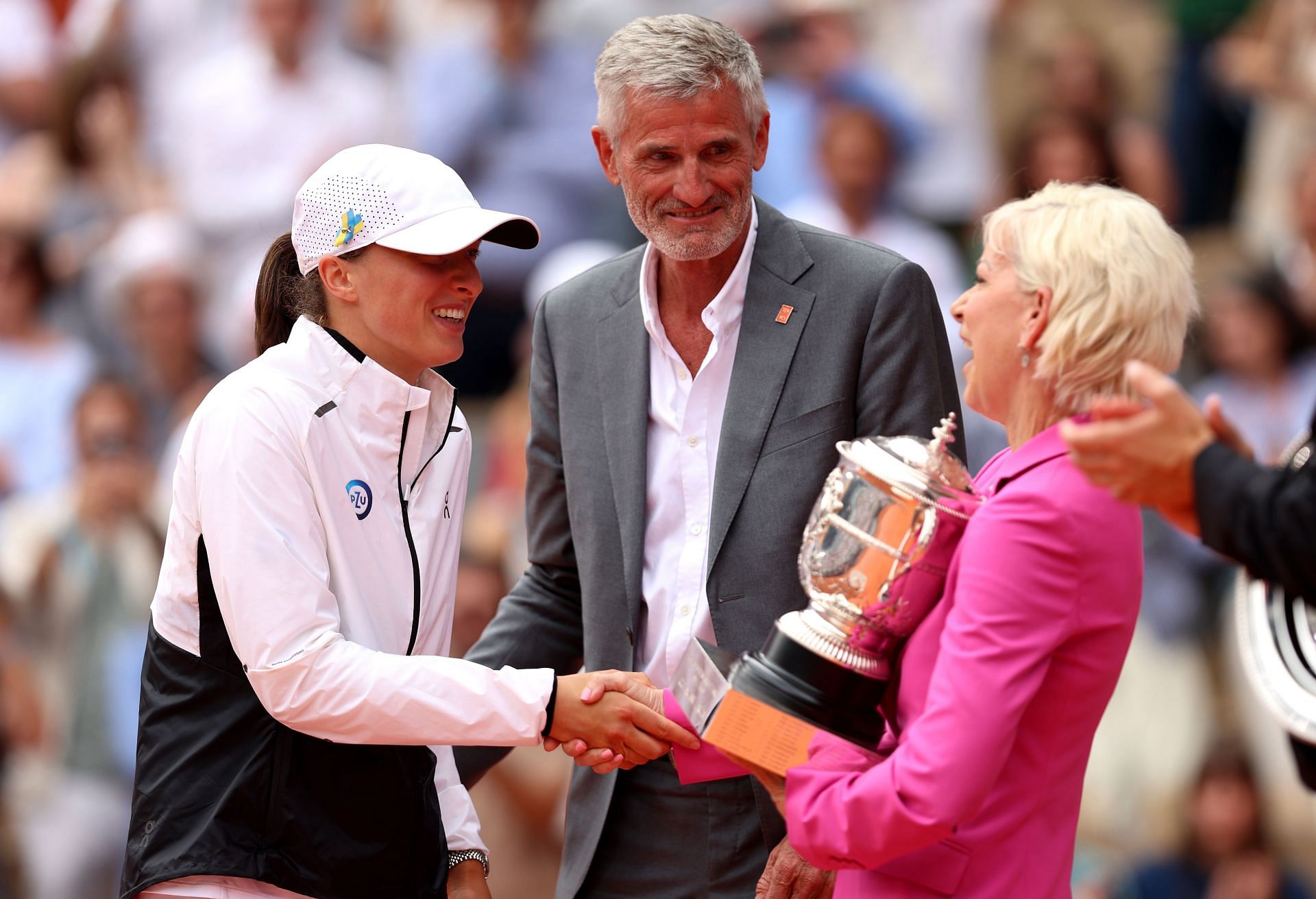 Iga Swiatek(L) gets the trophy from Chris Evert(R) - 2023 French Open