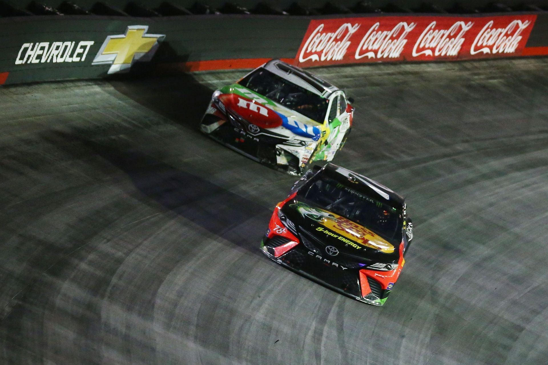 Martin Truex Jr., driver of the #78 Bass Pro Shops/Ducks Unlimited Toyota, leads Kyle Busch, driver of the #18 M&amp;M&#039;s White Chocolate Toyota. (Photo by Sarah Crabill/Getty Images)