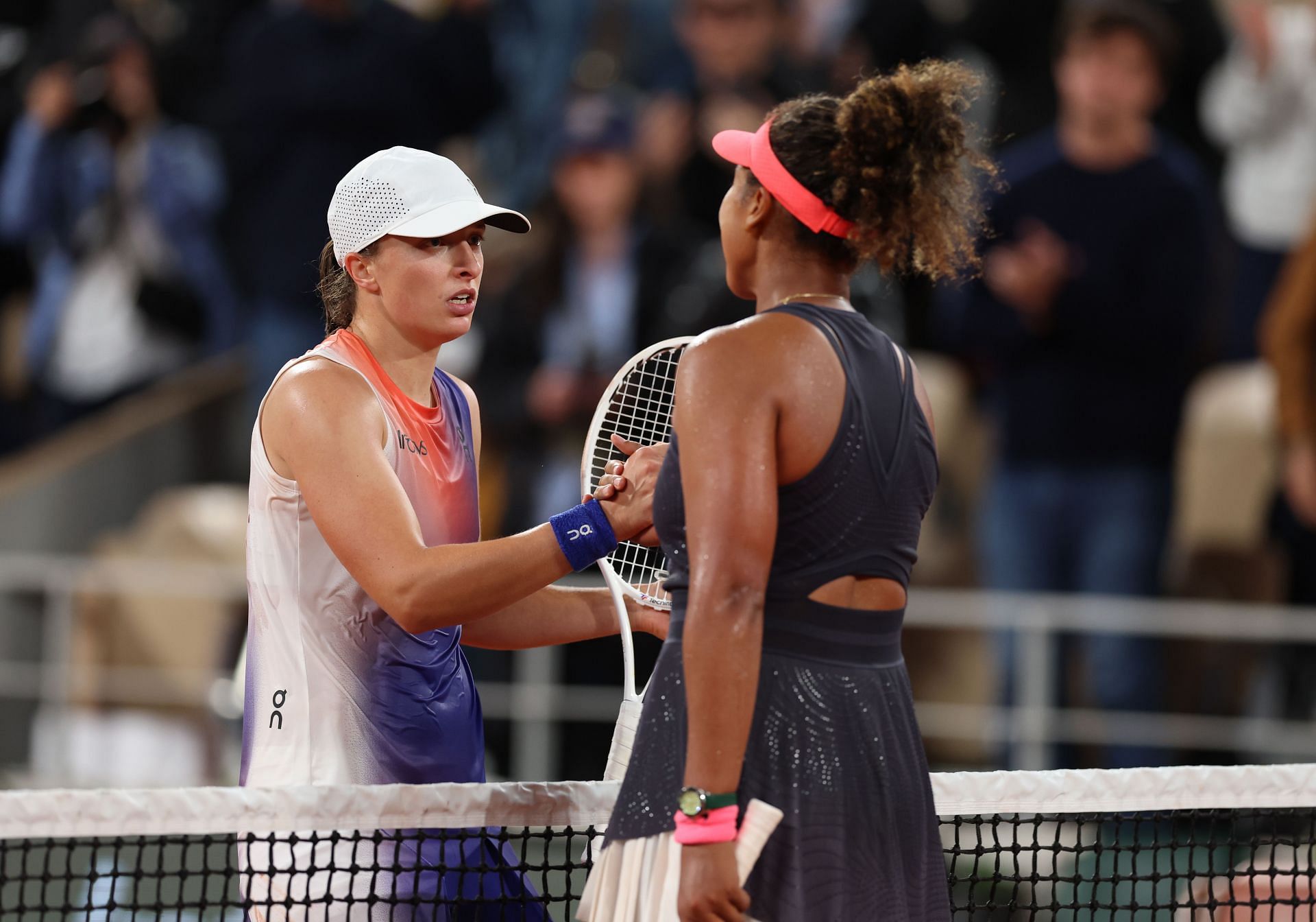 Naomi Osaka and Iga Swiatek greet each other after their 2024 French Open clash