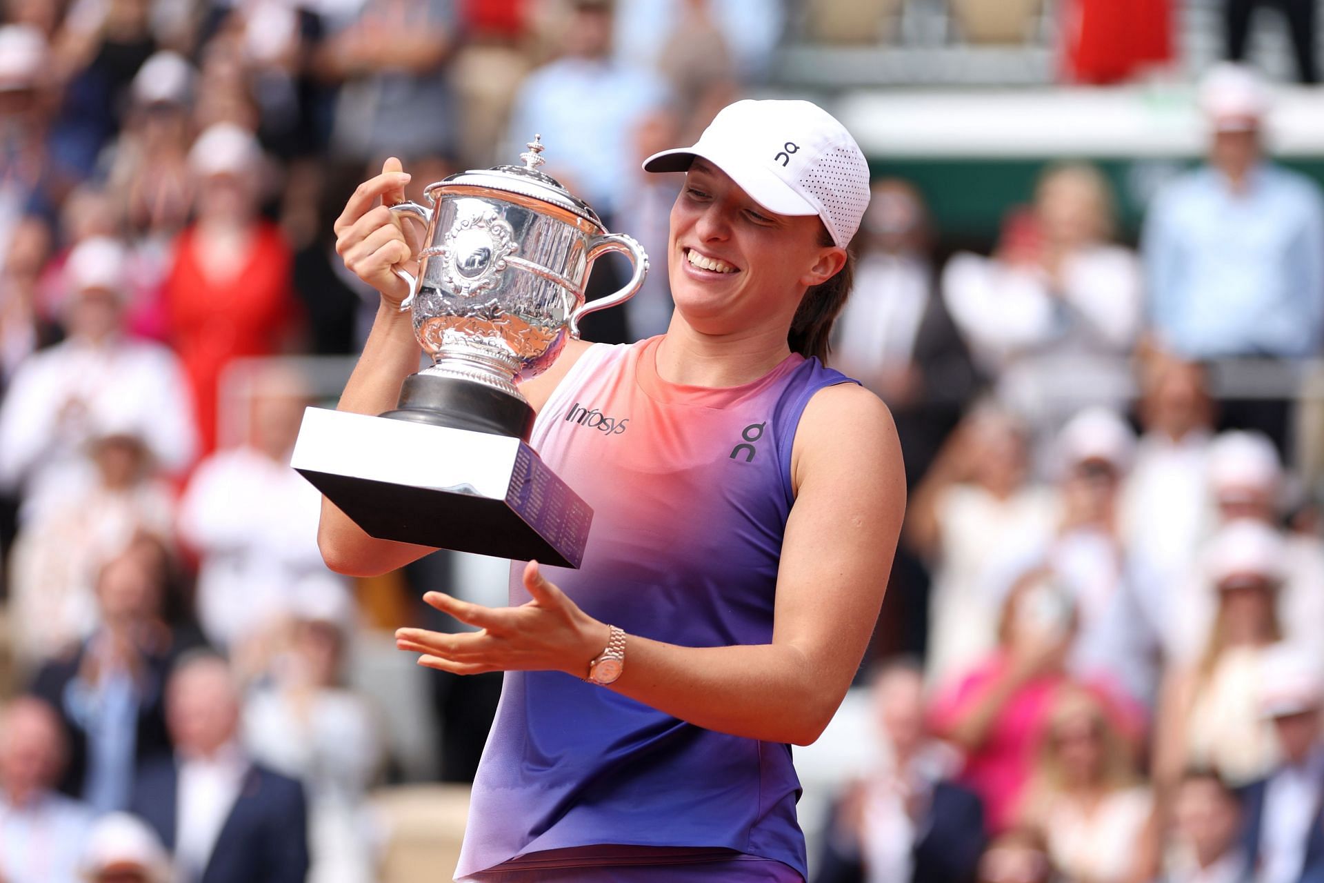 Iga Swiatek with her 2024 French Open trophy which was presented by Martina Navratilova and Chris Evert.