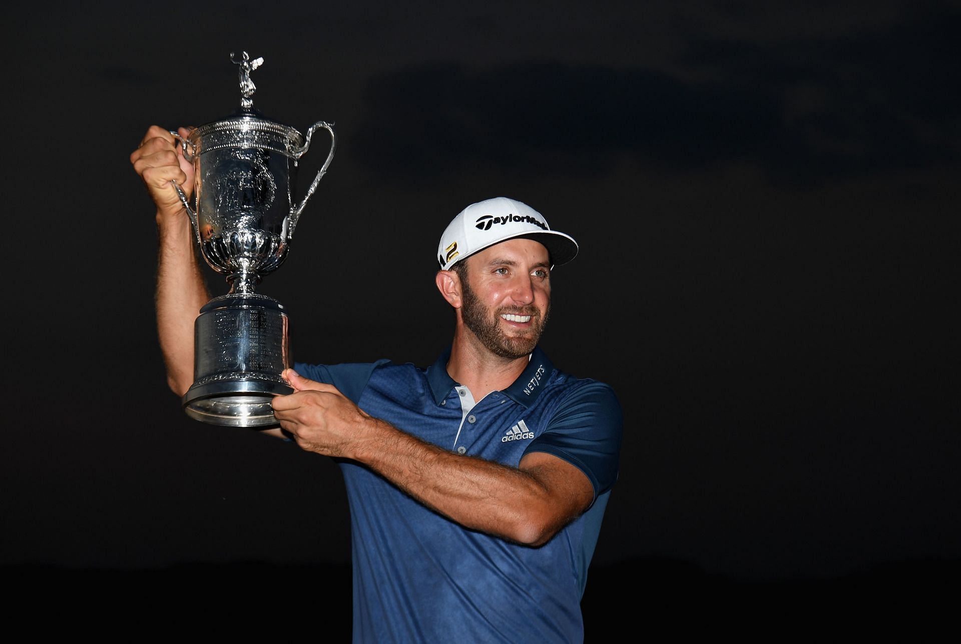 Dustin Johnson poses after winning the US Open 2016