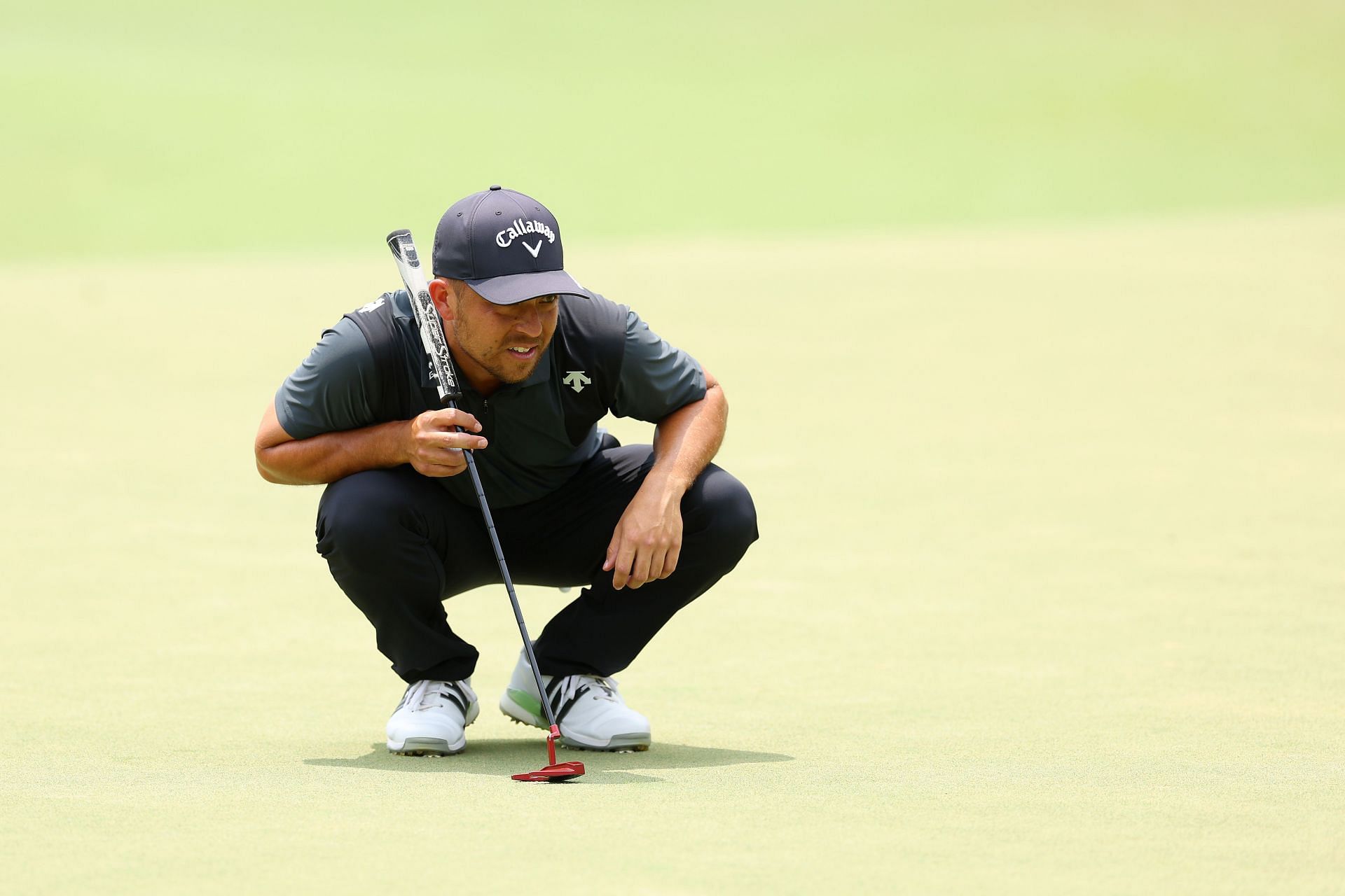 Xander Schauffele looks over a putt on the fourth hole during the final round of the US Open