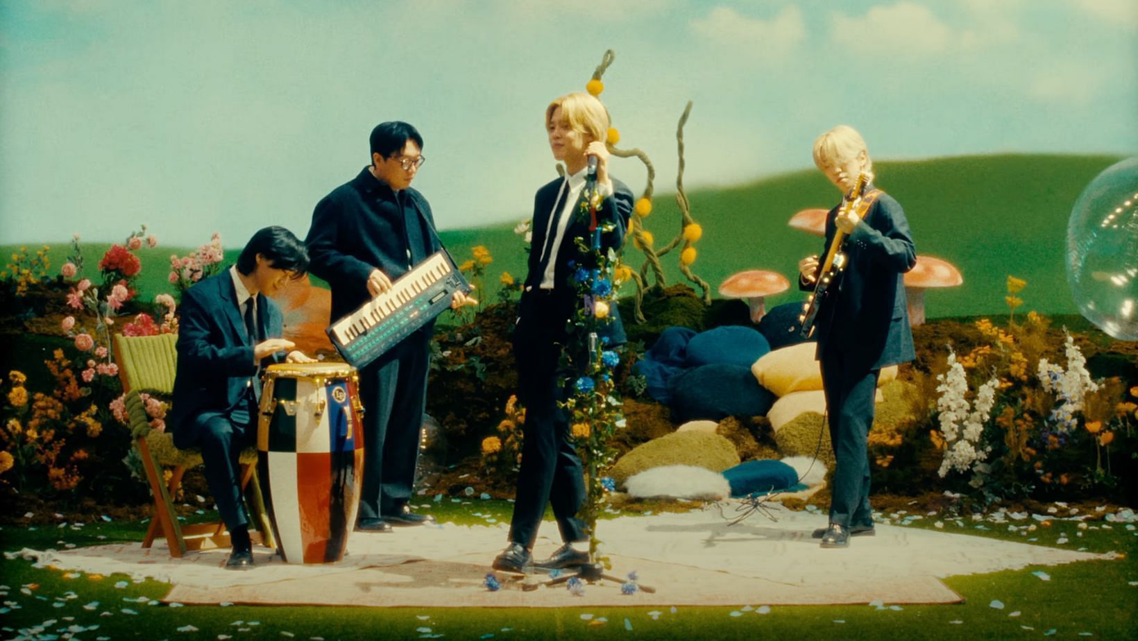 Pdogg, GHSTLOOP, and Evan&rsquo;s cameo debut in BTS Jimin&rsquo;s &ldquo;Smeraldo Garden Marching Band&rdquo; MV. (Image via YouTube/HYBE LABELS)