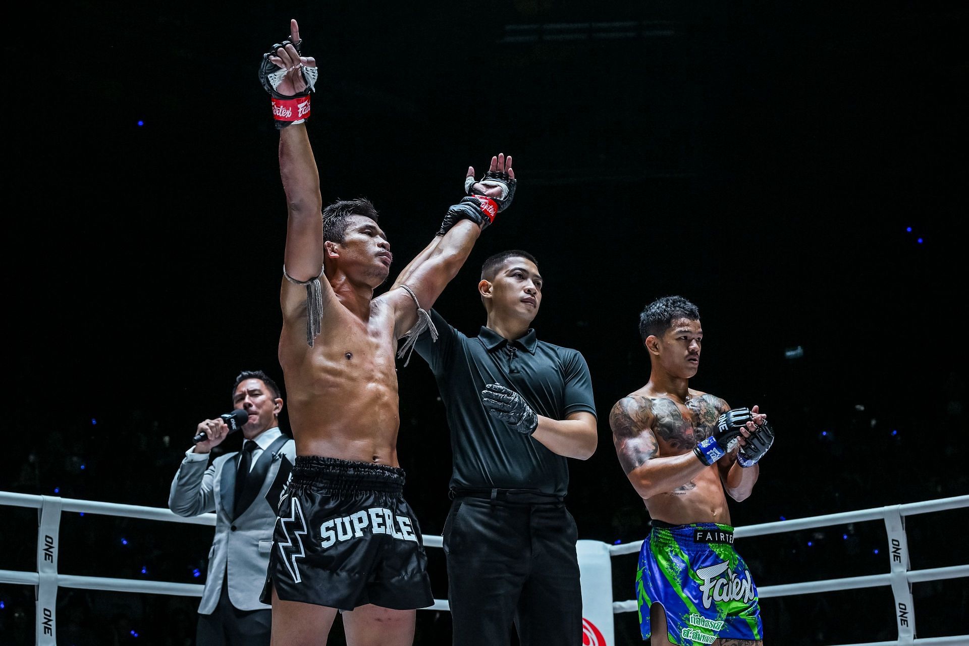 Superlek&#039;s arm is raised after his decision win over Kongthoranee.