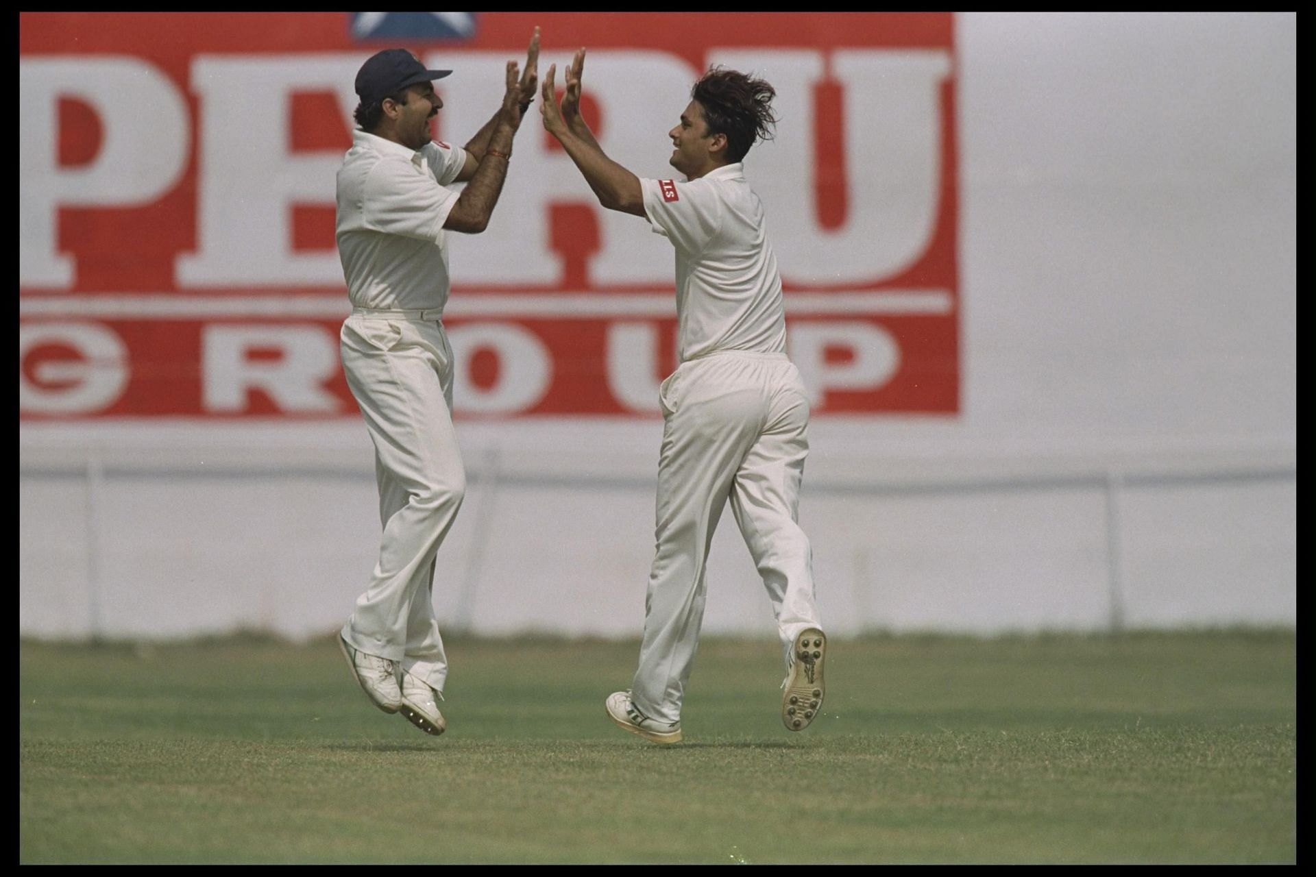 Mohammed Azharuddin of India and teammate David Johnson celebrate the wicket Michael