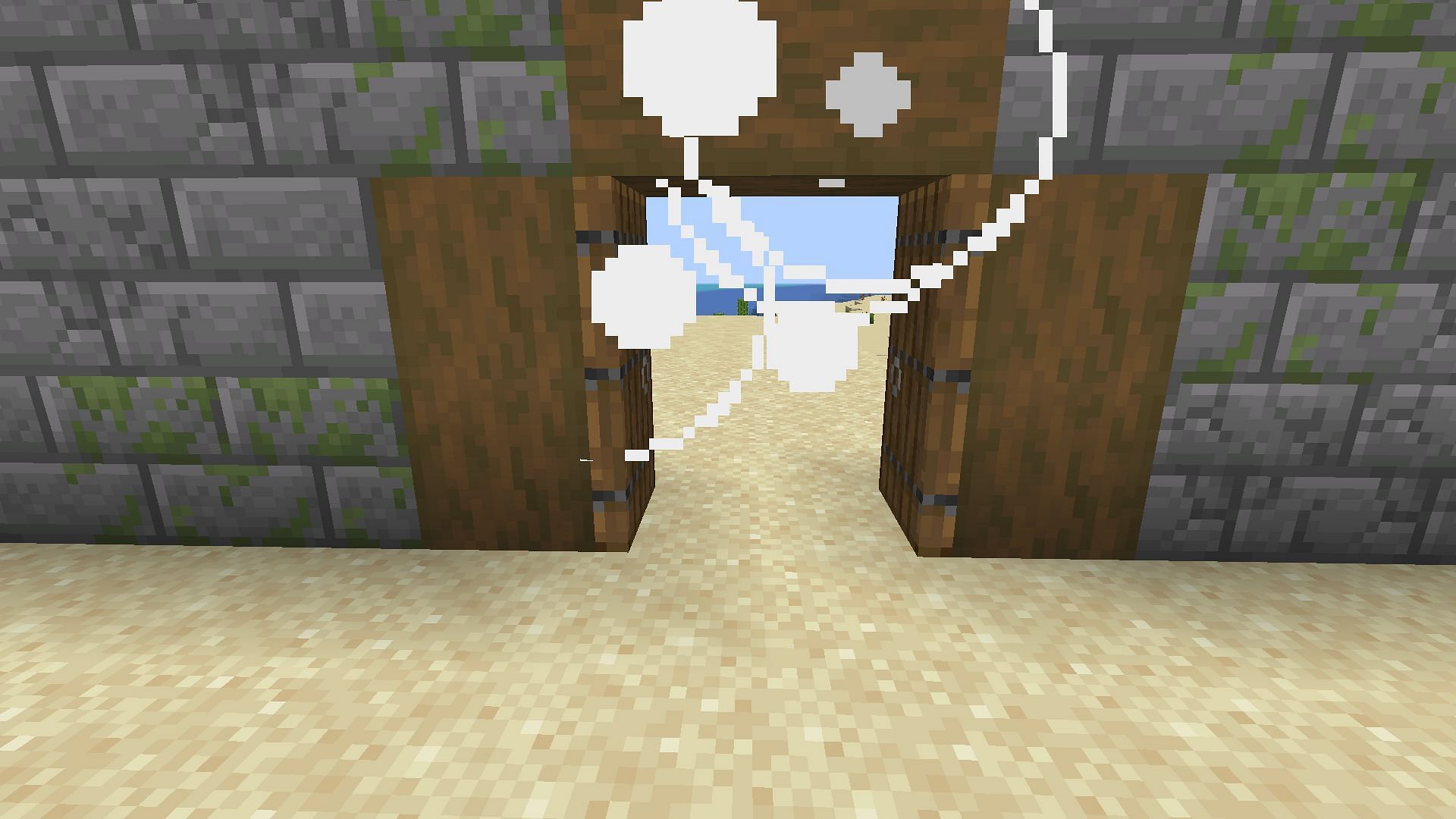 A wind charge opening a pair of wooden doors (Image via Mojang Studios)